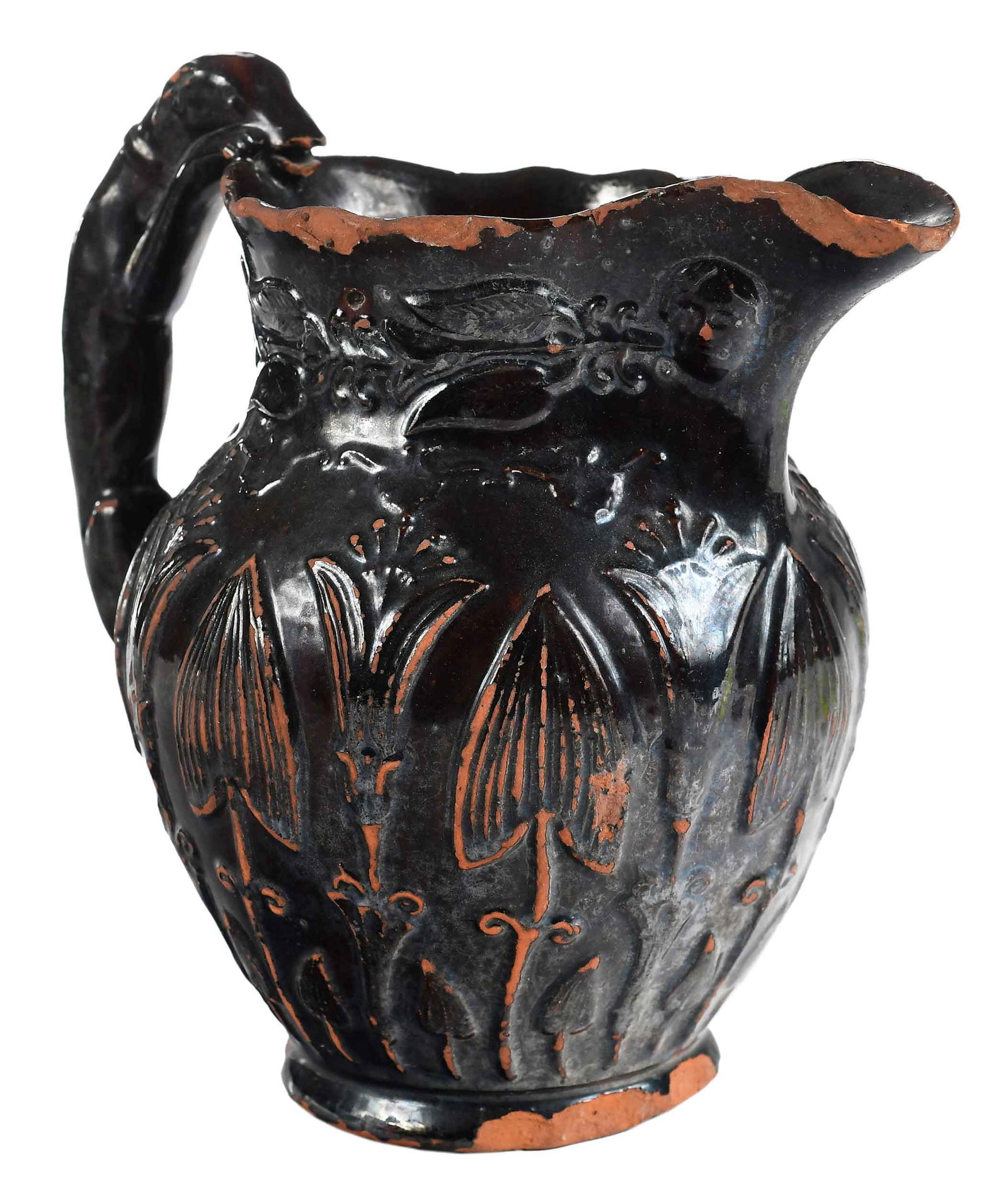 Rare Nathaniel Sellers Molded Redware Pitcher with Hound Handle: Upper Hanover, Pennsylvania, circa 1840-60, impressed to base "Nathaniel Sellers/Upper Hanover,/Pa.", lead and manganese glazed interior and exterior, molded tulip and mask motif, 8-1/2 x 8