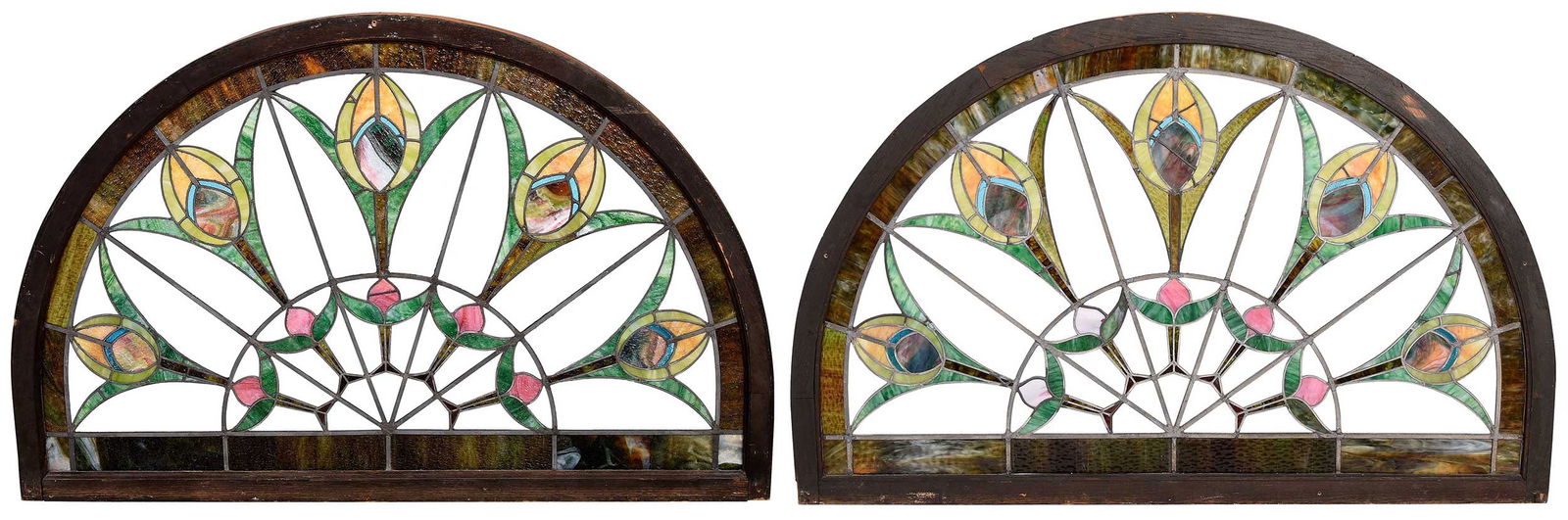 Pair of Large Arched Stained Glass Windows with Stylized Floral Panels: late 19th century, in demilune wood frames, 40-1/2 x 61 x 1-3/4 in. Provenance: Brunk Auctions, Asheville, North Carolina, February 26, 2000, sold for $3,400; Private Collection, Knoxville, Tenne