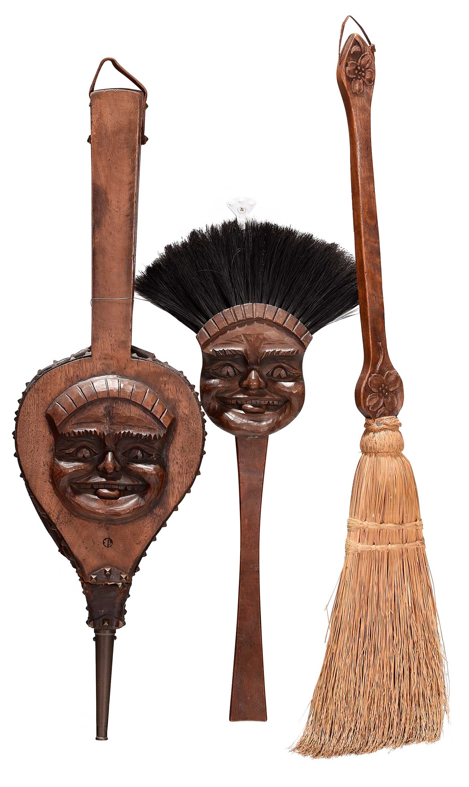 Three Biltmore Industries Carved Fireplace Tools: North Carolina, early 20th century, "Forward" and "Biltmore, NC" marks, comprising: "Golliwog" hearth brush; bellows; broom; largest item 33 x 7 x 1 in. Provenance: Priva