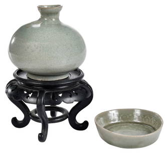 Chinese Celadon Small Dish and Ovoid Vase with Stand: late Qing dynasty, each in crackle glaze, larger 3-3/4 x 4-1/8 x 4-1/8 in.; with carved wood stand, 3-3/8 x 5 x 5 in.Provenance: Private Collection