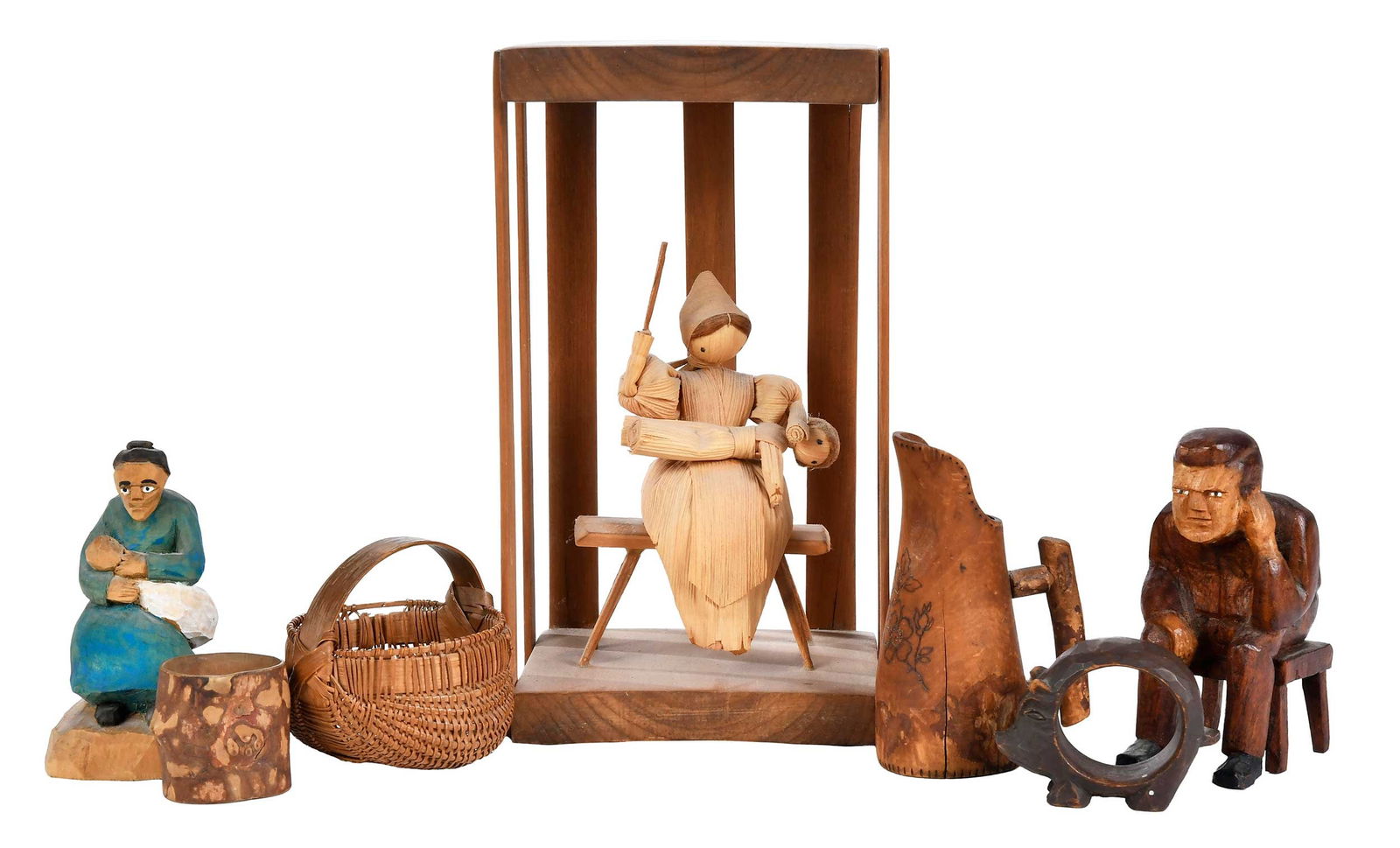 Seven Assorted Small Folk Art Decorative Objects: American, 20th century, including disciplinary figural scene, two carved wood seated figures, egg basket, pitcher/tankard, Kodiak Alaska pig form ring, and bark napkin ring initialed "R.H.D.", largest