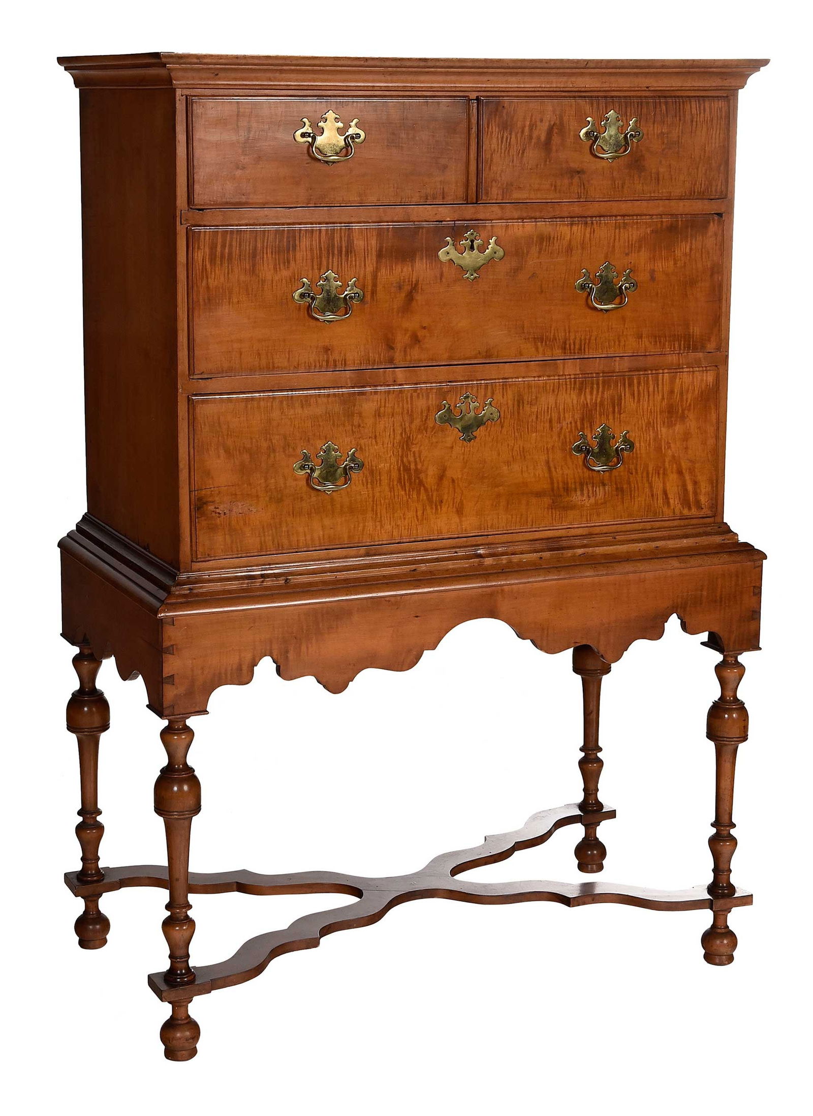 New England William and Mary Figured Maple Chest on Frame: 18th century elements, with three long graduated drawers resting on a later conforming base, chestnut secondary, 58 x 38-1/2 x 20 in. Provenance: Estate of Diane Parker, Thomasville, Georgia
