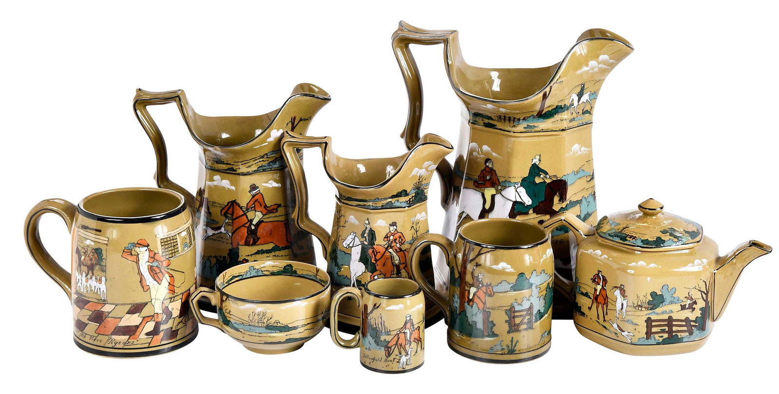 23 Pieces Deldare Ware Buffalo Pottery Tableware: American, 20th century, Buffalo Pottery marks to bases, "The Fallowfield Hunt" pattern, comprising: three pitchers, two teapots, eight tea cups, seven mugs, creamer, sugar, and waste, larges