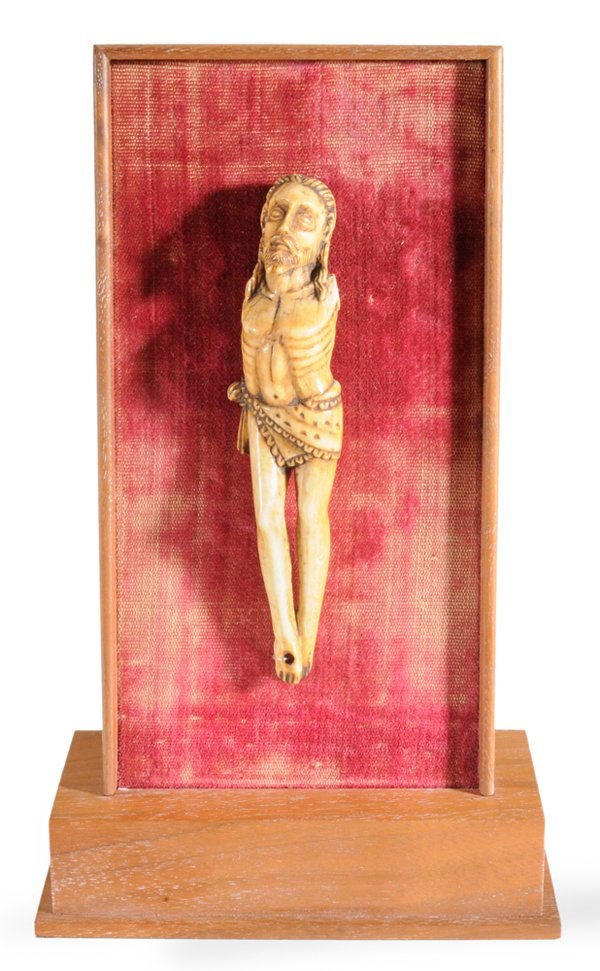 Indo-Portuguese School: (17th/18th century) Corpus Christi, carved ivory with fringed parazonium, 4-3/4 in., now mounted on a wood and velvet-lined easel-form stand, lacking arms, shrinkage cracks, other surface wear, not re