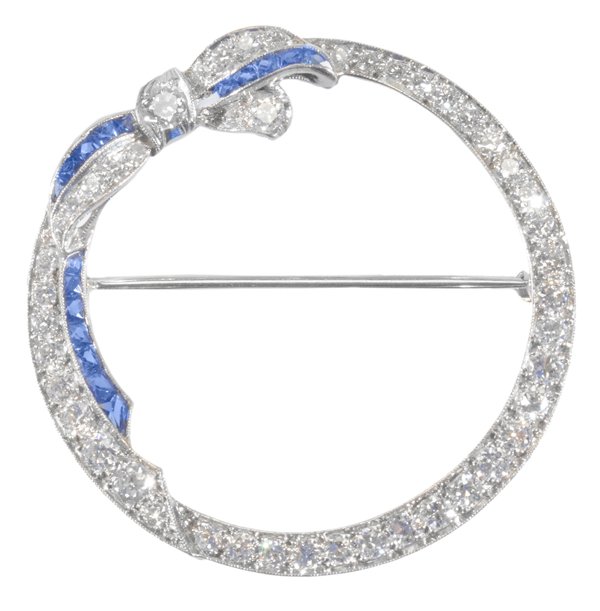 Vintage Circle Pin: vintage platinum, diamonds, blue sapphires circle pin with ribbon bow accent, set with approximately 45 Old European and round full-cut diamonds having an estimated combined weight of 1.85 cts., clari