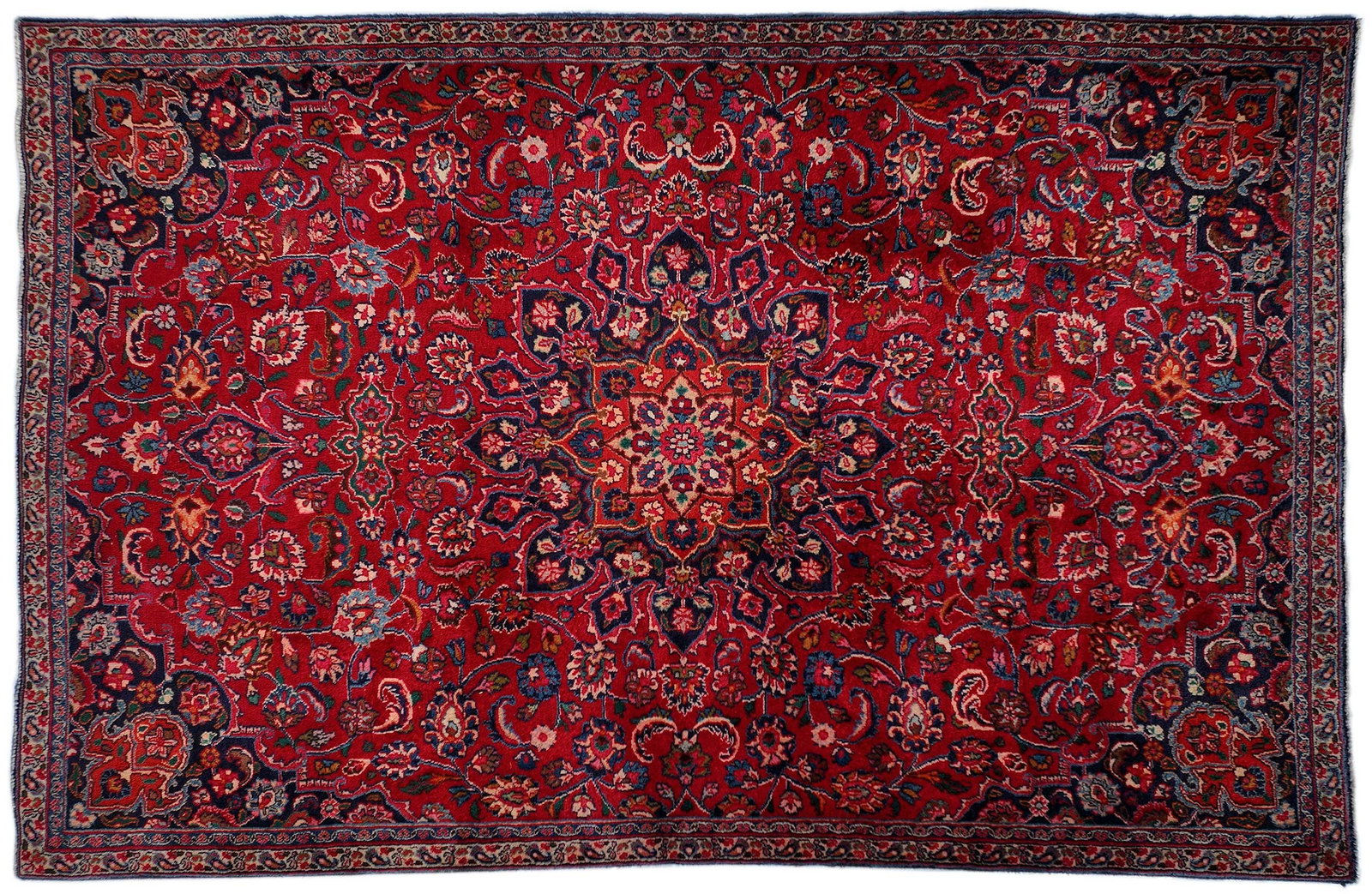 Sarouk Gallery Rug: 20th century, central blue polygonal medallion, red field with trailing flowers, 9 ft. 3 in. x 6 ft. 3 in. Provenance: Private South Carolina Collection