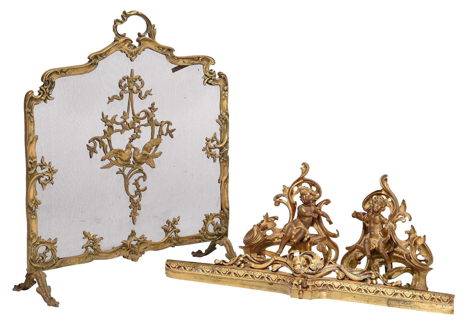 Four Gilt Bronze Fireplace Accessories: 19th century, comprising: pair of putti and scroll chenets; firescreen with birds; and scroll decorated fender; largest 31 x 26 x 9-1/2 in. Provenance: Private Collection