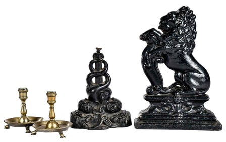 A Pair of Continental Brass Candlesticks with Two Iron Doorstops