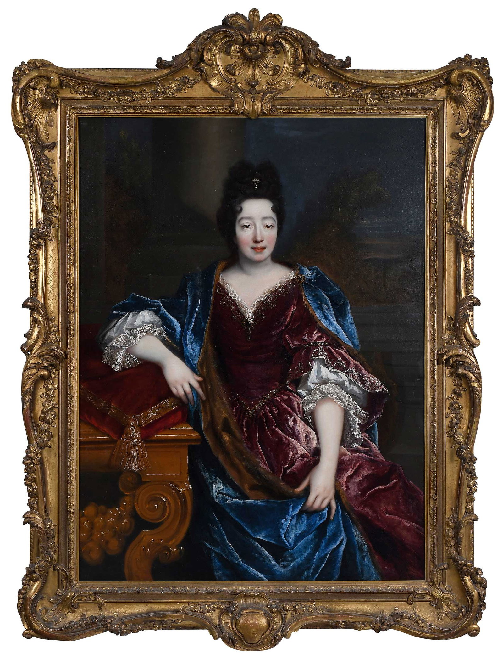 Attributed to Francois de Troy, Portrait of a Noblewoman: (French, 1645-1730) Possibly Louise Benedicte de Bourbon, Duchesse Du Maine, in a blue and red velvet gown, seated on a terrace by a console table, oil on canvas, 54-1/2 x 41-5/8 in.; fine gilt wood a