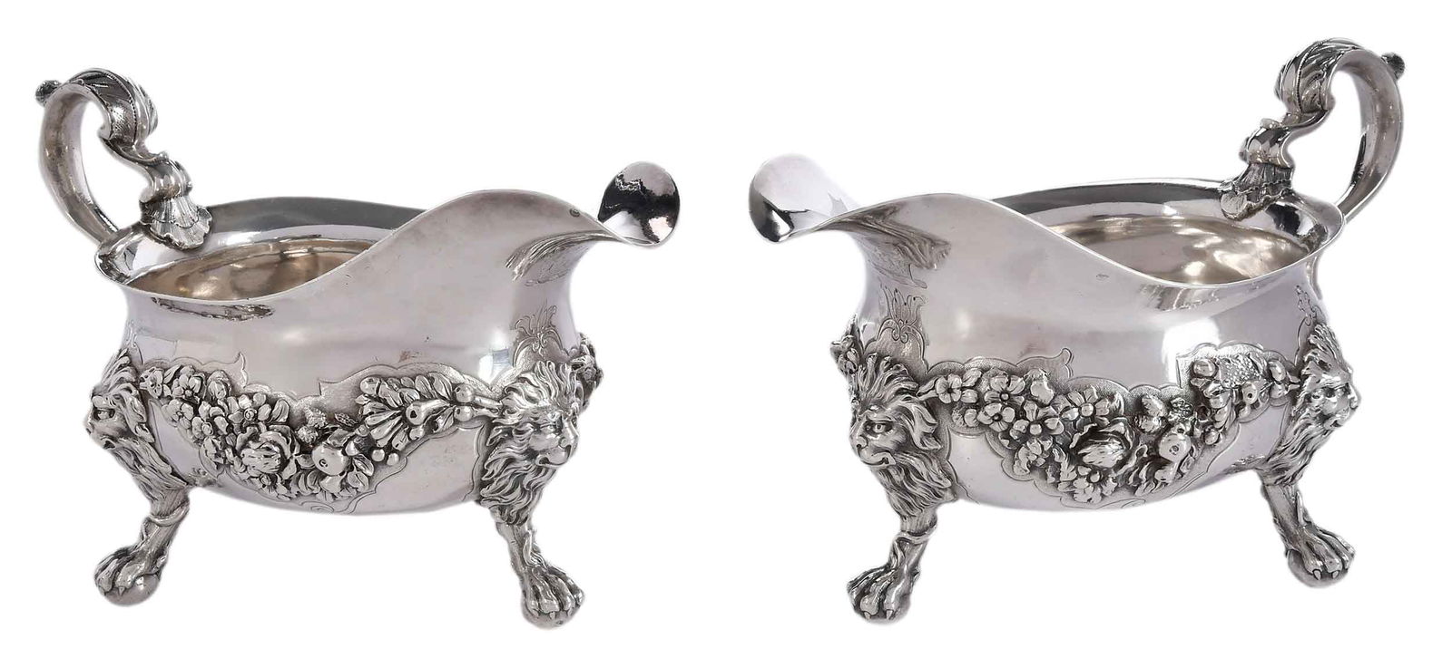 Pair of George II English Silver Sauce Boats, George Wickes: London, 1742, helmet form with floral swag on a matted ground, scroll handle, lion mask and paw feet, engraved crest under spout, marks for George Wickes, .925 fine, 40.15 oz. T., 5 x 8-1/4 x 4-1/2 in