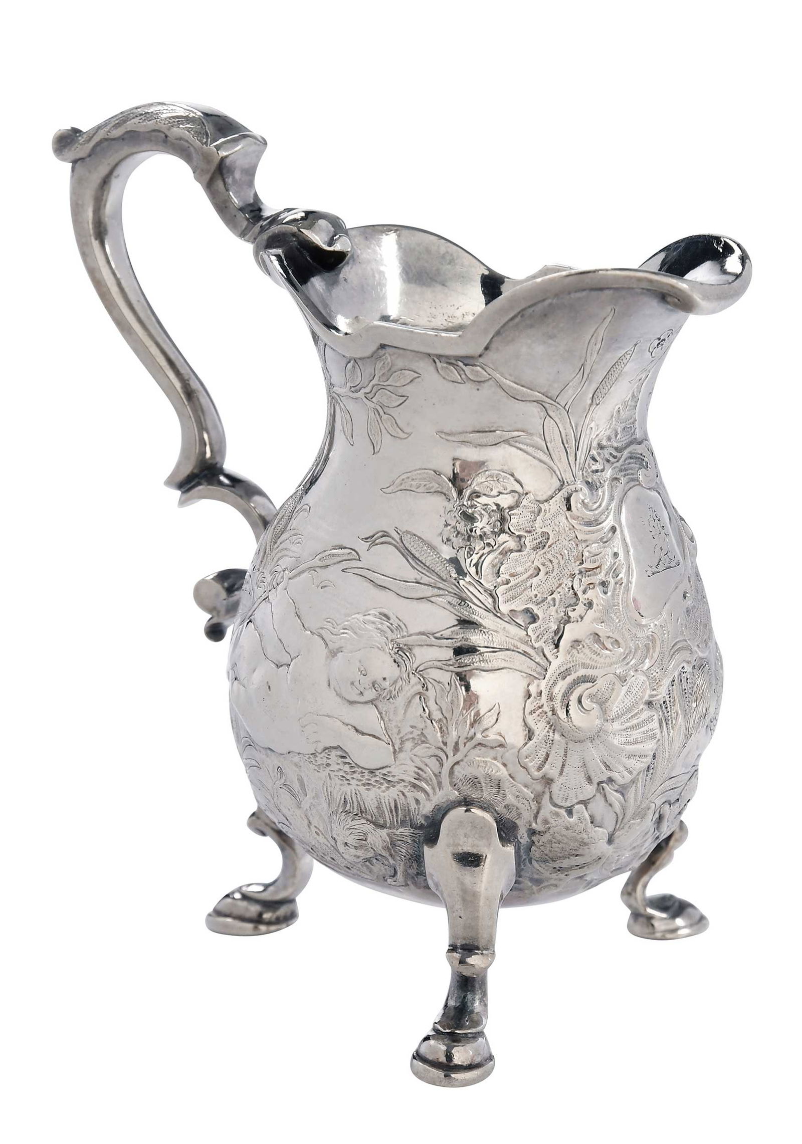 George II English Silver Creamer, John White: London, circa 1740, pear form with finely chased with fountains, cows, dolphins, and reclining putti, three hoof feet, scroll handle, cartouche with crest, marks for John White, .925 fine, 6.49 oz. T.