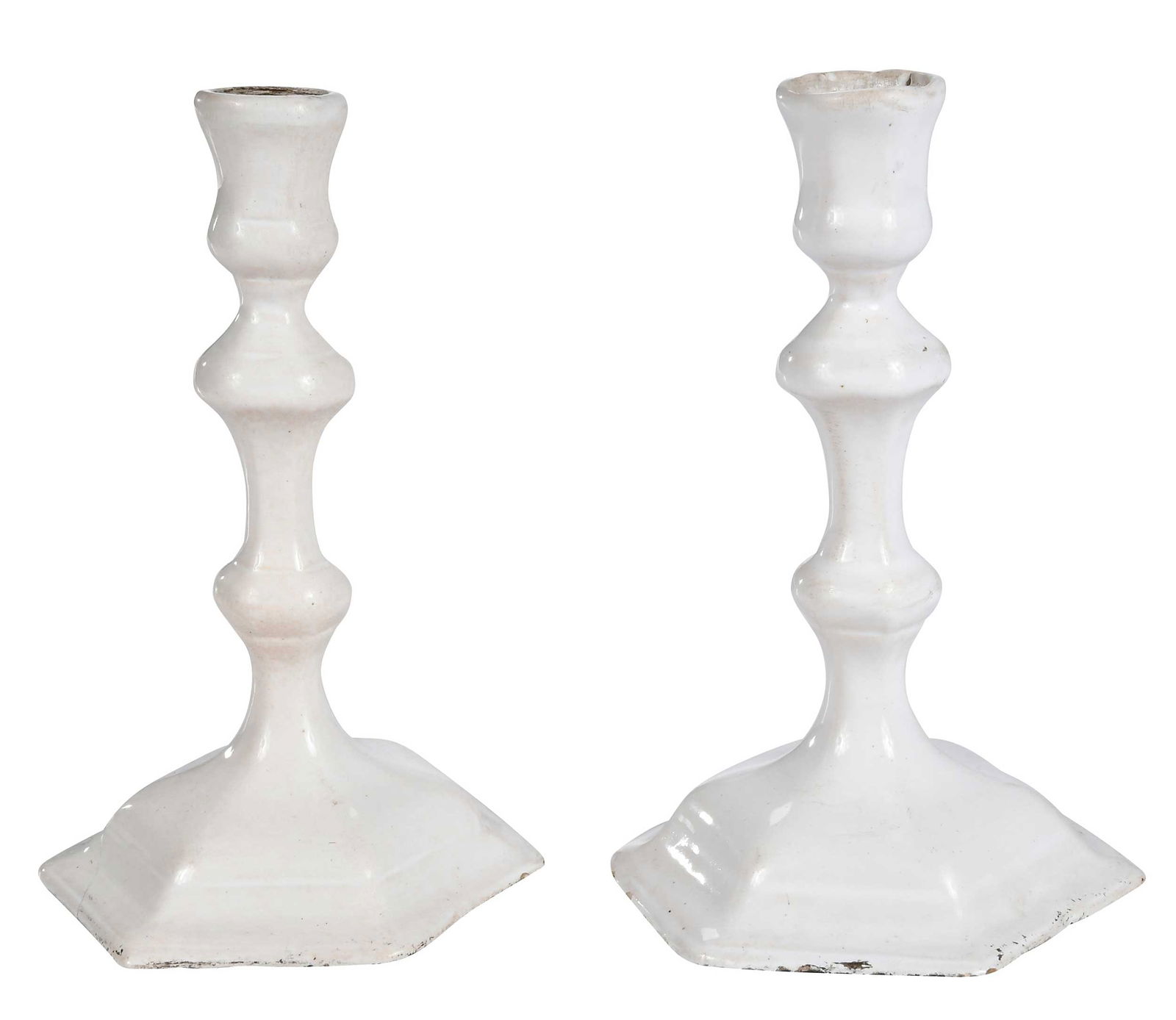 Pair of Delft White Glazed Candlesticks: probably Continental, 18th century, hexagonal bases and multi-knopped stems, 6-1/2 x 3-5/8 x 4-1/4 in. Provenance: Collection of John B. and Marie-Teresa Vander Sande, Newbury, Massachusetts Note: A n