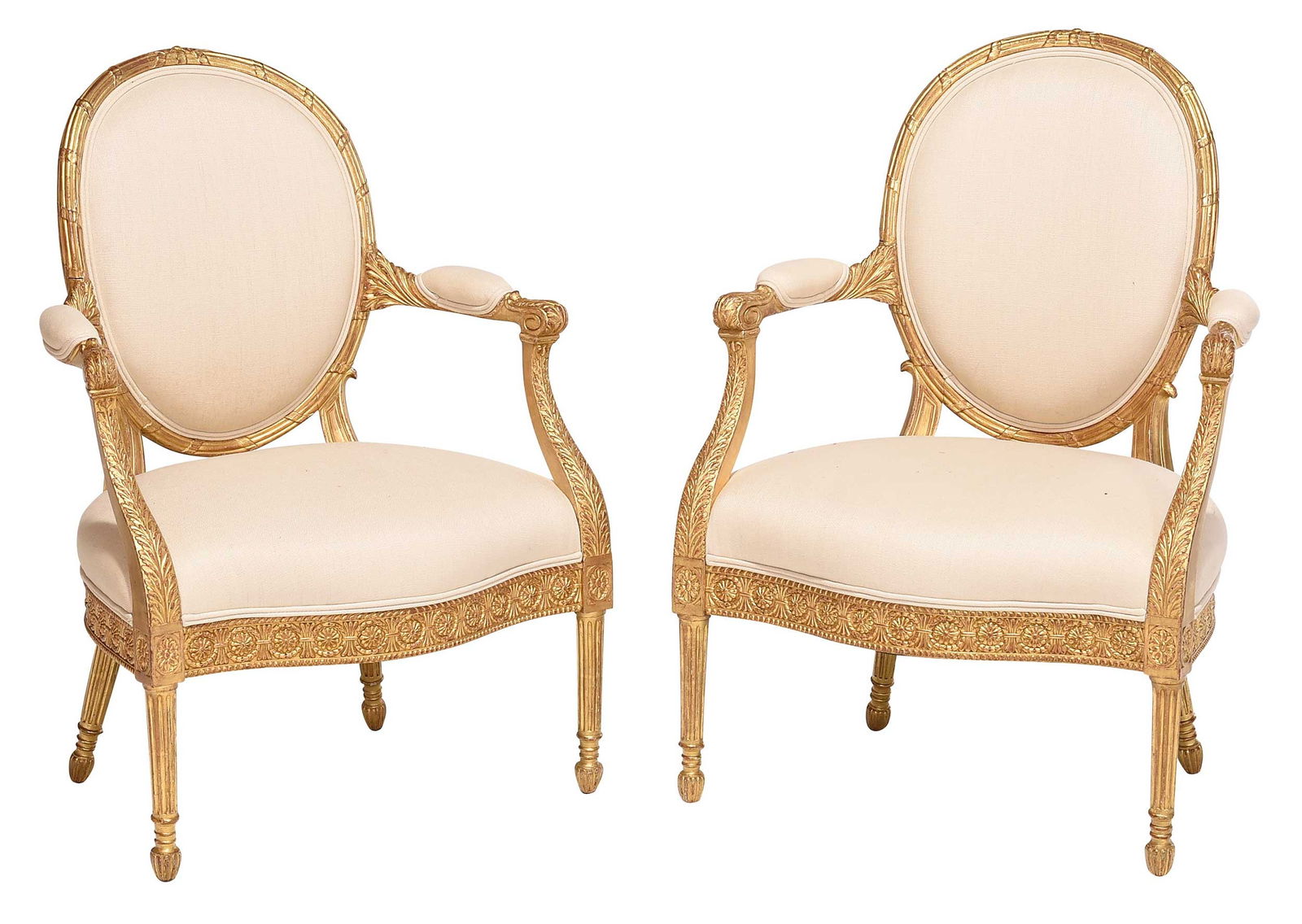 Pair Louis XVI Style Carved and Gilt Wood Open Armchairs: probably French, 20th century, each with carved frame with serpentine front rail, cream upholstery, 39 x 28 x 19 in.