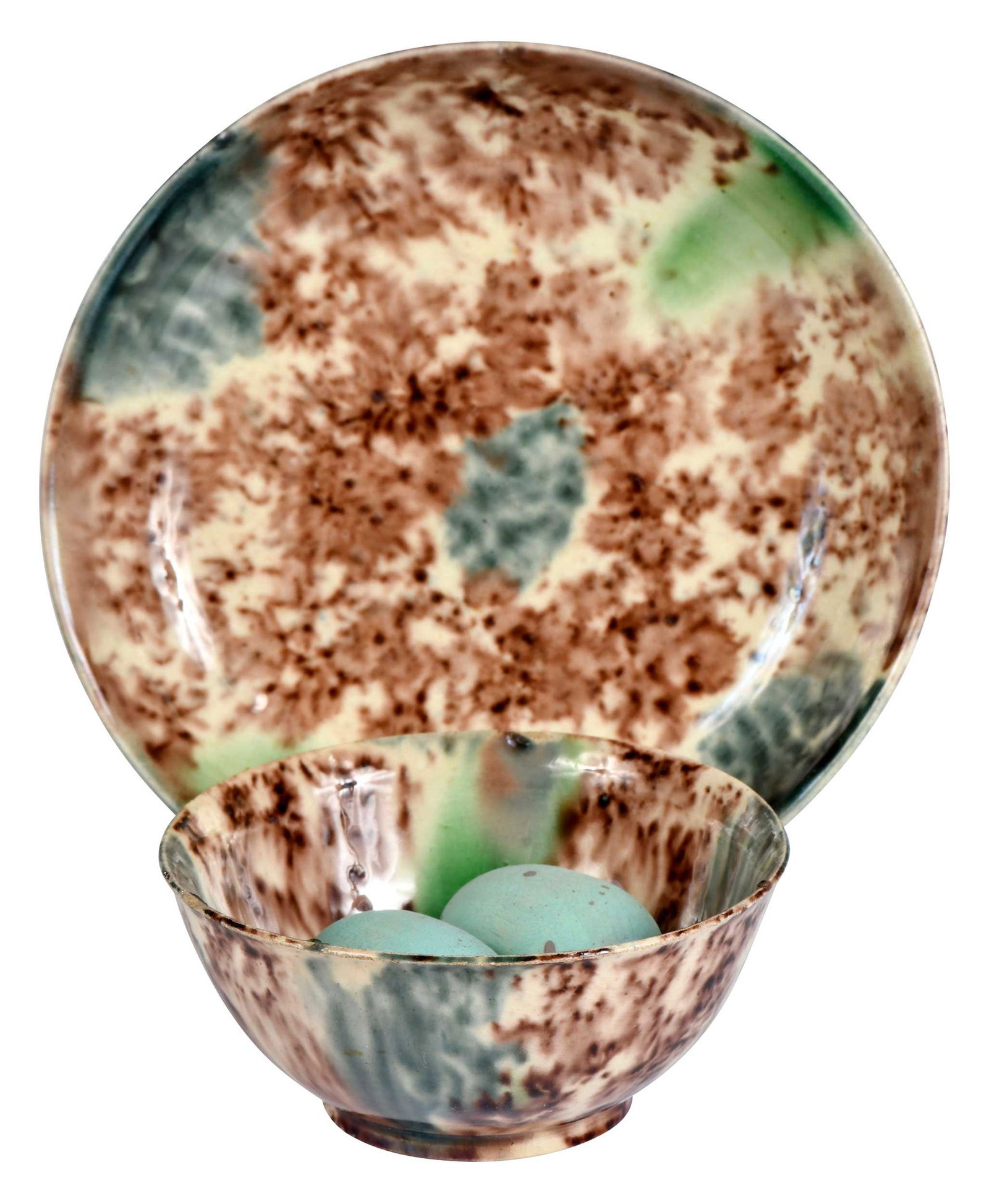 Whieldon Type Tortoiseshell Glaze Tea Bowl and Saucer: English, 18th century, bowl 1-1/2 x 3-1/4 x 3-1/4 in., saucer 1-1/8 x 4-7/8 x 4-7/8 in., with two associated blue painted wood bird eggs Provenance: An Important Atlanta Private Collection