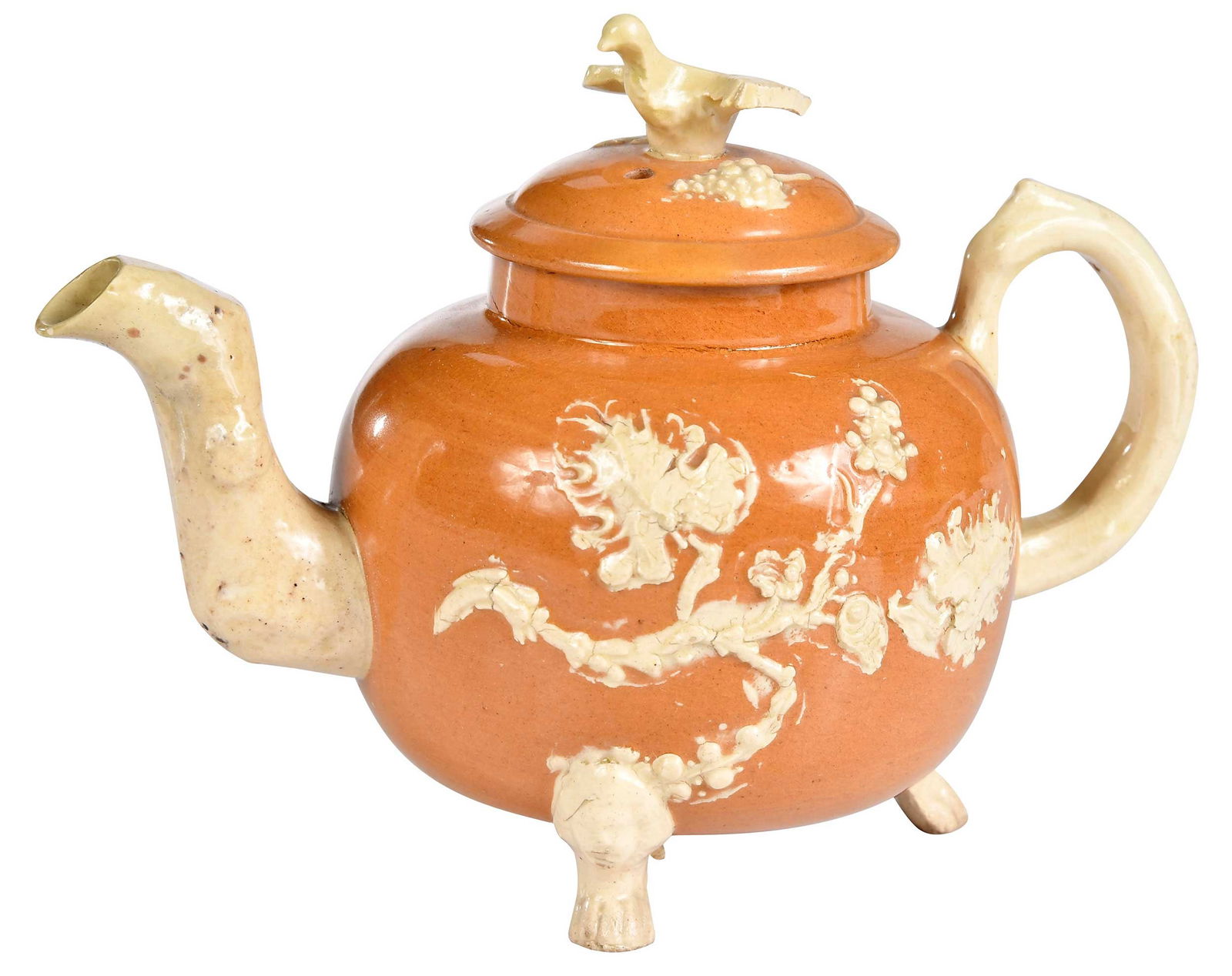 Astbury Type Lidded and Footed Teapot: English, 18th century, decorated with applied cream leaves and sprigging, 4-3/4 x 6-1/4 x 4 in. Provenance: Art Trading Ltd. (David B. Newbon), New York (label); An Important Atlanta Private Collectio