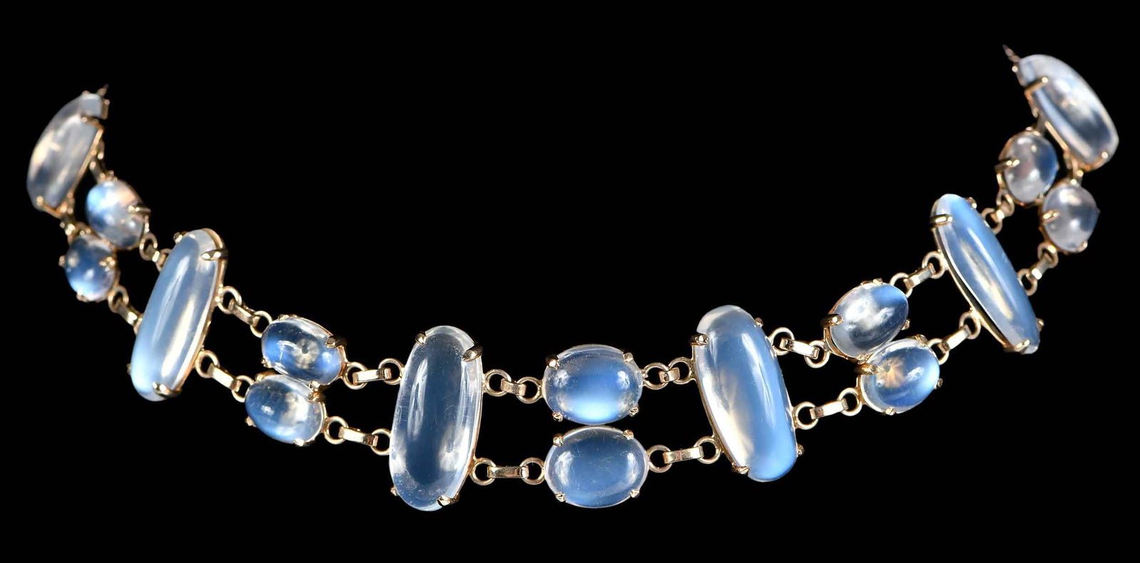 14kt. Moonstone Double Chain Necklace: 16 cabochon cut moonstones, marked "14K", yellow gold, 13 in. length, 20.0mm wide, with extra chain, total weight 24.5 g Provenance: Private Collection, New York Note: Brunk Auctions makes no warranty