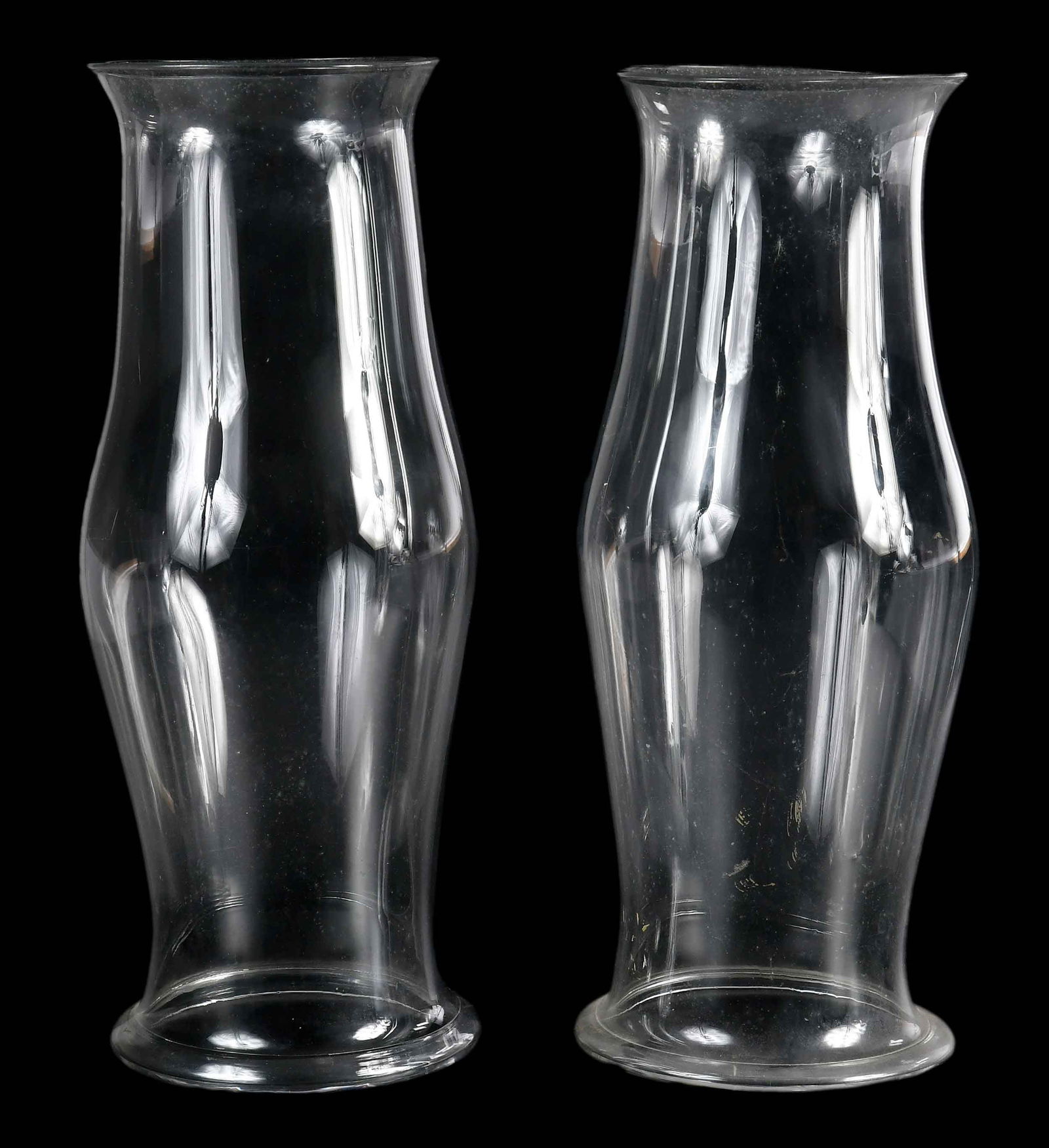 Large Pair of Hurricane Glass Shades: 19th century, blown glass with rolled bases, 22-1/2 x 9 x 9 in. Provenance: Estate of Gary L. Johnson, Virginia