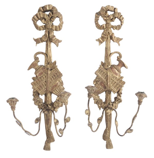 Pair Italian Louis XVI Style Carved: and Gilt Wood Two-Light Sconces 20th century, backs marked "Palladio Hand Carved in Italy", each with ribbon-carved crest and two gilt iron leaf-decorated candle arms, 28-1/2 x 11-1/2 x 7-1/2 in., goo