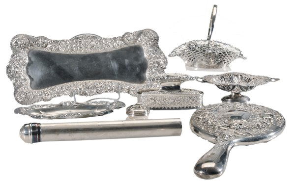 Eight Ornate Sterling Dresser Pieces: American, 20th century: Gorham hand mirror with cupids and floral decoration; two baskets; two pin trays; Gorham nail buffer and case; lidded box; Reed & Barton toothbrush holder, most sterling, 13.44