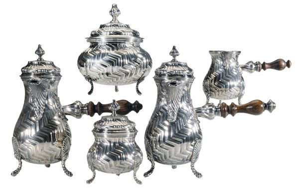 Tiffany Sterling Five-Piece Tea: Service 20th century, pear forms with scroll and shell feet, zigzag pattern, turned wooden handles, two 10-1/4 in. coffee/tea pots with matching covered sugar, covered waste, creamer, retailer Tiffany