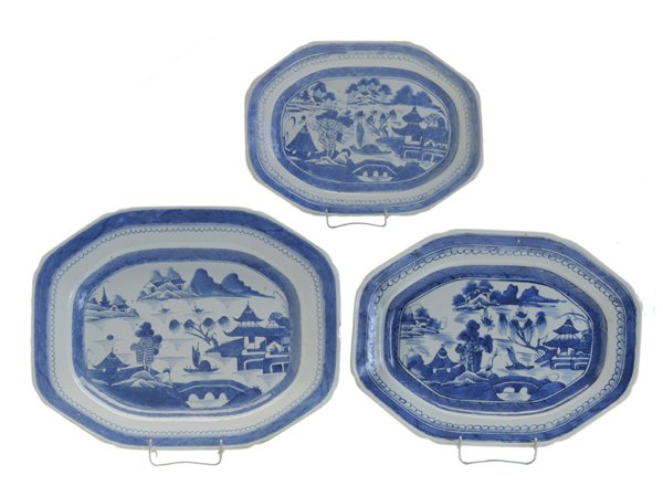 Nest of Three Canton Blue and White: Platters Chinese, 19th century, each with traditional Canton pagoda and lake scene: 1-3/4 x 15-3/4 x 12-3/4 in., [rim chip on side, minor rim flakes; 1-1/2 x 13-3/4 x 10-5/8 in., [good condition,] 1-1