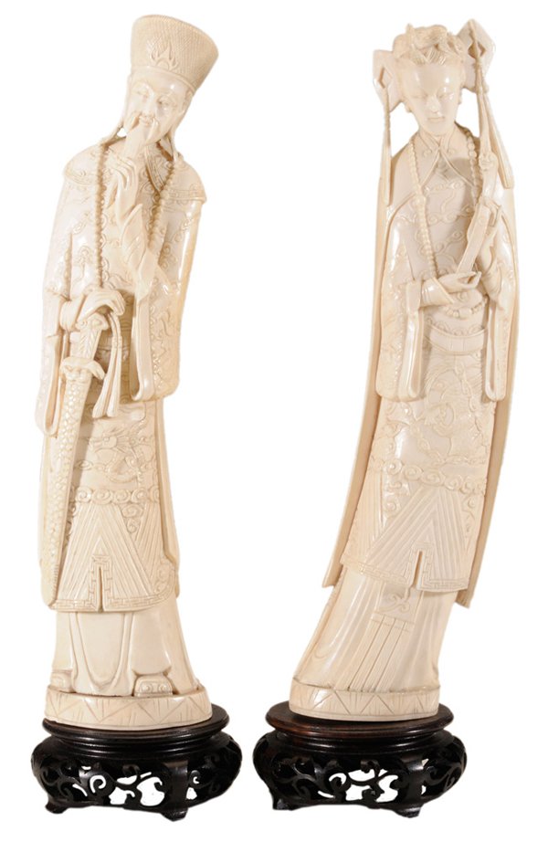 Two Carved Ivory Standing Figures,: Emperor and Empress Chinese, early to mid 20th century, each in elaborate dress, emperor with hands on beard and sword, empress holding a scepter, Qianlong mark on base, 11-1/4 x 2-3/4 in., raised on 