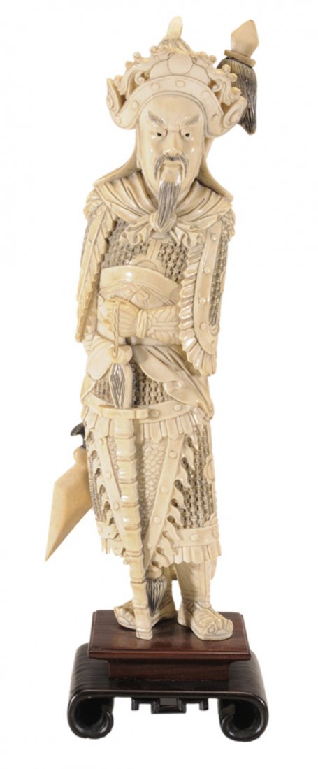 Carved Ivory Standing Figure of: General probably Chinese, early to mid 20th century, inked ivory, dressed in armor and holding a sword and a spear, top of crown removable, on stepped rosewood and teakwood base, 17-1/4 x 5-1/4 x 3-3/