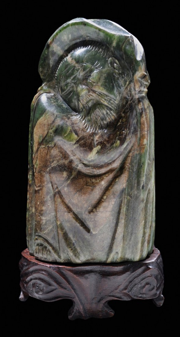 Carved Jade Figure: Chinese, 20th century, nephrite, mottled green and tan, sleeping elder carved on all sides with rind used as accent color, simply executed, imitating Ming and Qing ivory tusk sculptures, label "P2" at