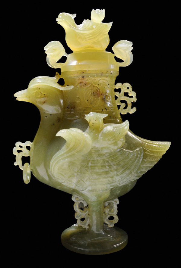Hardstone Carving of Lidded Duck: Vase Chinese, 20th century, possibly serpentine in mottled green with some translucency, dark speckles and infusions of brown in the glassy green, carved on all sides, duck form with duckling and lotu