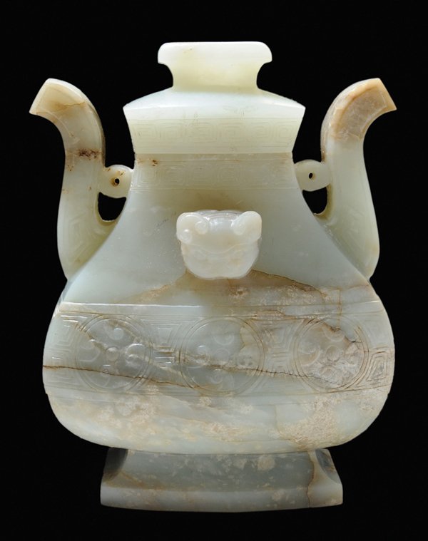 Carved Jade Lidded [Hu]-Shaped: Vase Chinese, in the Ming style, nephrite in mottled celadon green and tan, carved on both sides with belly band of whorls from late Zhou jade and bronze forms, delicate animal heads centered on shoul