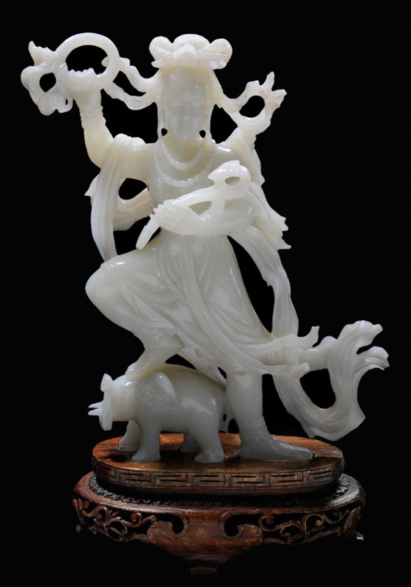 Carved Jade Lovely Lady Dancing: With Foot on Elephant Chinese, 20th century, jadeite in uniform white, skillfully carved Buddhistic figure, lady dancing, hoop and scepter in hands, scarves flying, right foot on compliant elephant, 7