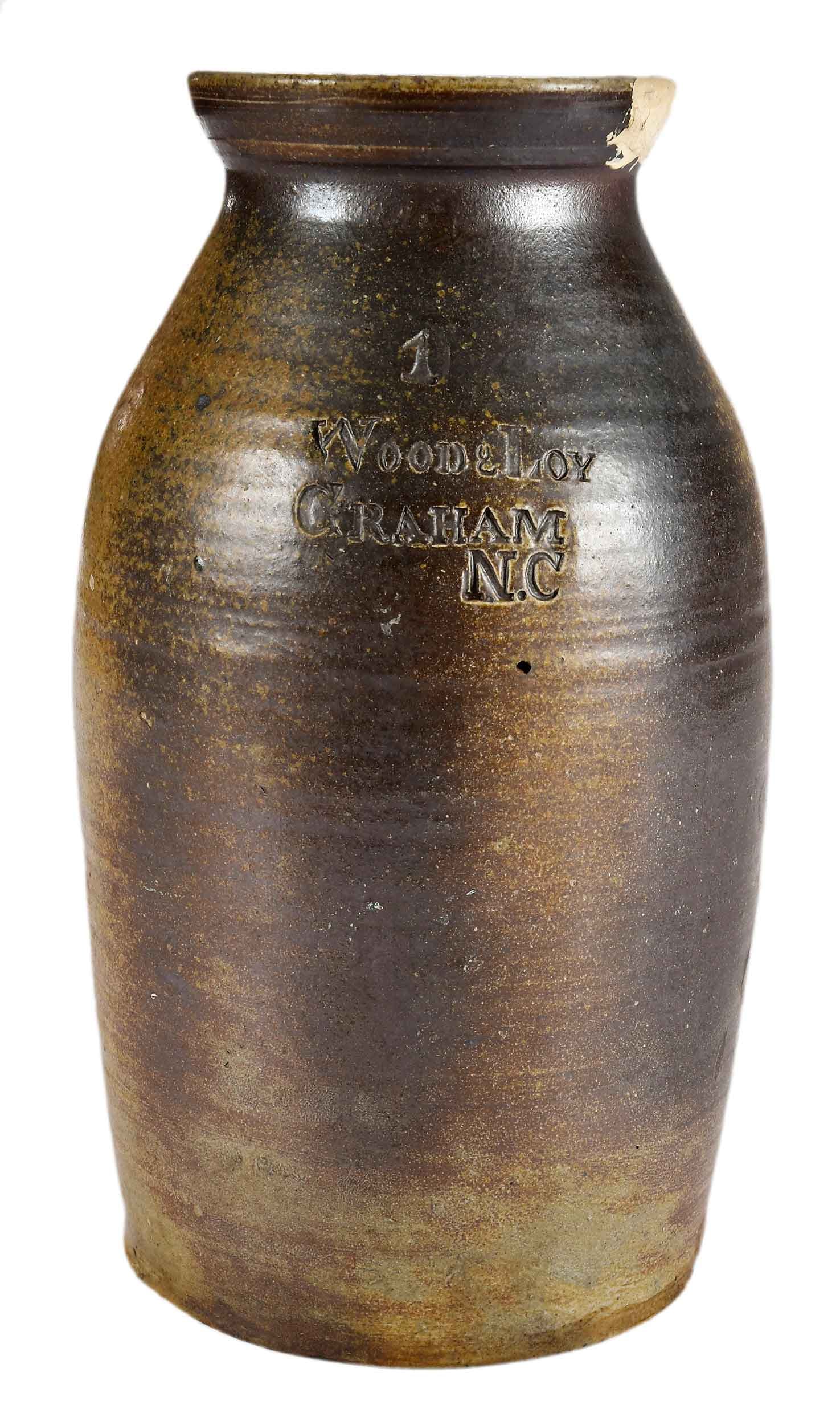 Scarce Wood & Loy Graham North Carolina Stamped Stoneware Storage Jar: (Alamance County, 1880-1900), maker's mark stamped at shoulder, 11 x 5-1/2 x 5-1/2 in. Provenance: Estate of Joe and Betsy Byerly, Greensboro, North Carolina