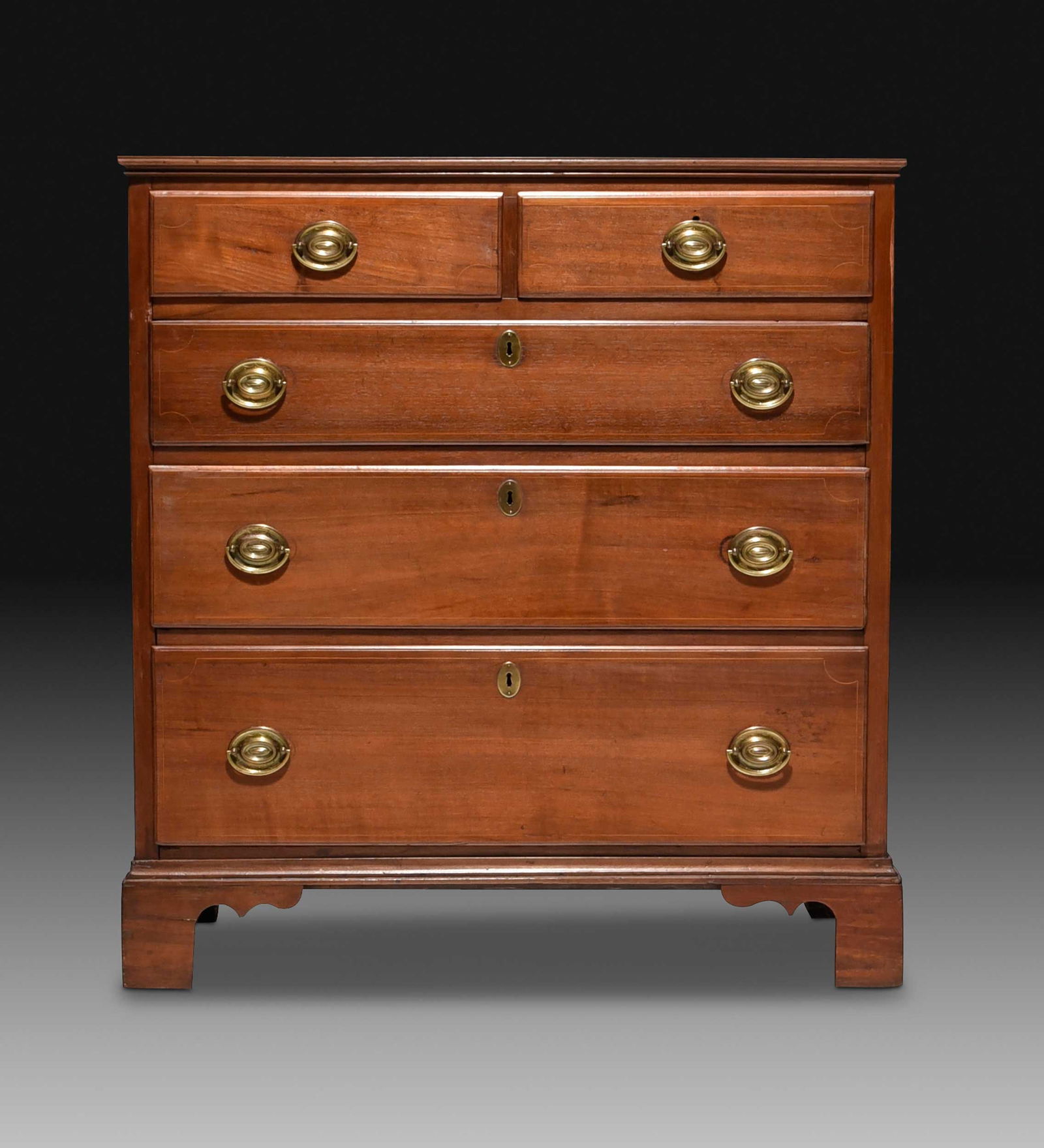 North Carolina Federal Inlaid Walnut Chest of Drawers: Piedmont, attributed to James Gheen (Rowan County, 1740-1796), late 18th century, yellow pine secondary, two short over three long thumbnail molded and dovetailed inlaid drawers, bracket feet and shap