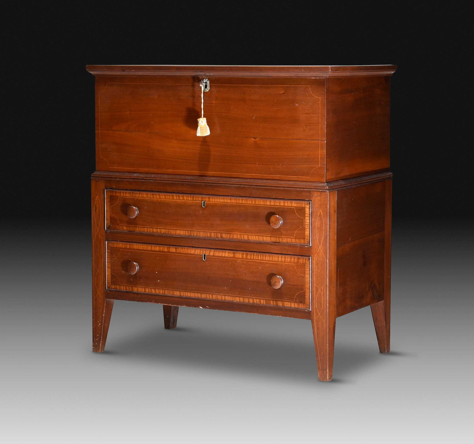 North Carolina Federal Inlaid Walnut Sugar Chest: Piedmont, first quarter 19th century, poplar and yellow pine secondary, figured walnut, dovetailed and cut nail construction, the interior with two dividers, base with two long cock beaded and figured