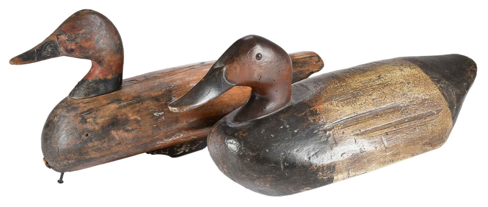 Two North Carolina Canvasback Drake Decoys: Currituck Sound, North Carolina, early 20th century, one with replaced head (possibly Ned Burgess), strong keel and chine, remnants of painted eyes, 9 x 17-1/2 x 7 in.; other with strong head profile,