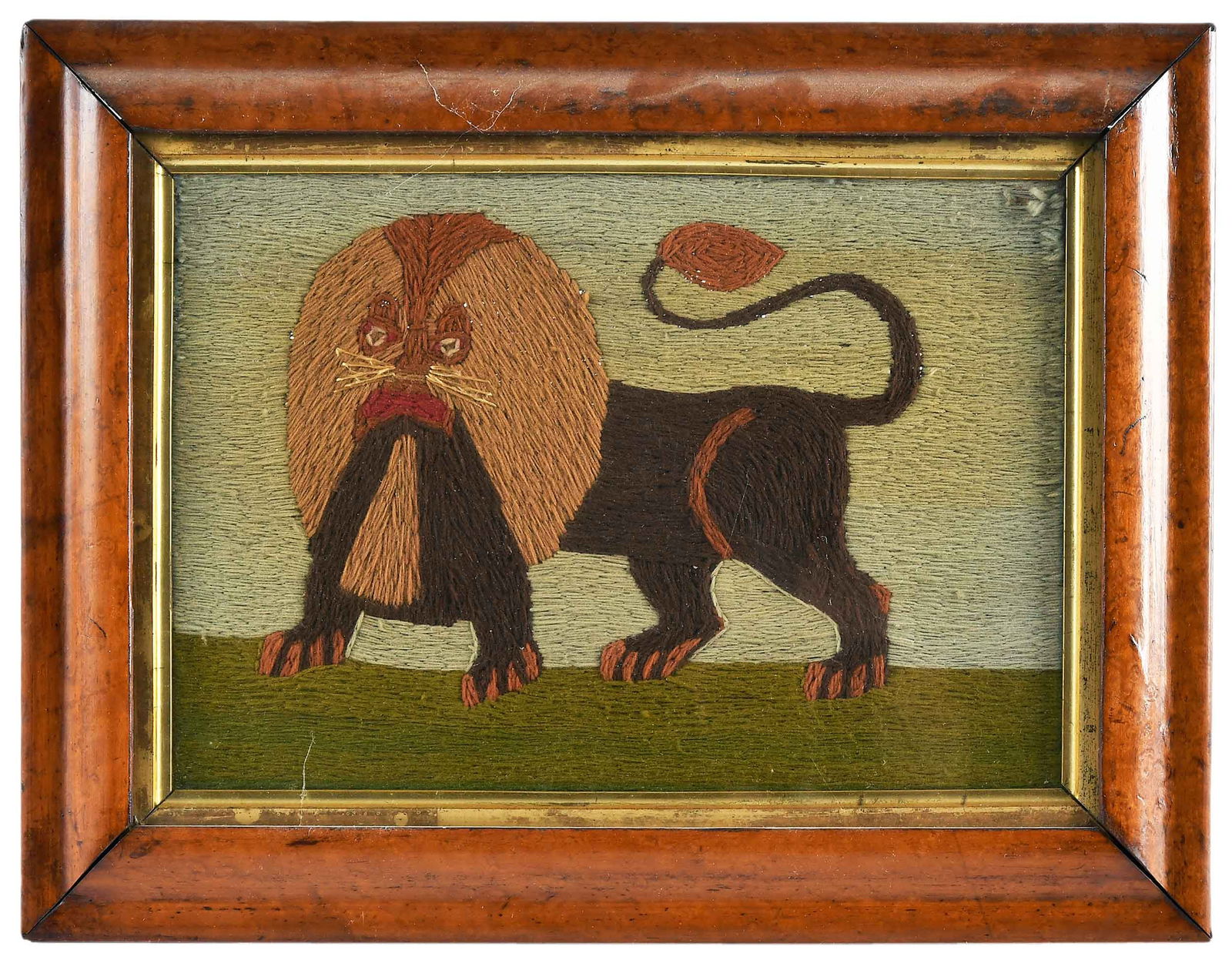 Framed English Folk Art Lion Needlework: 19th century, wool on linen, 8-1/2 x 12 in.; burl wood frame with remnants of old framer's label verso, 11-1/8 x 14-5/8 x 1/2 in. Provenance: Estate of Joe and Betsy Byerly, Greensboro, North Carolina