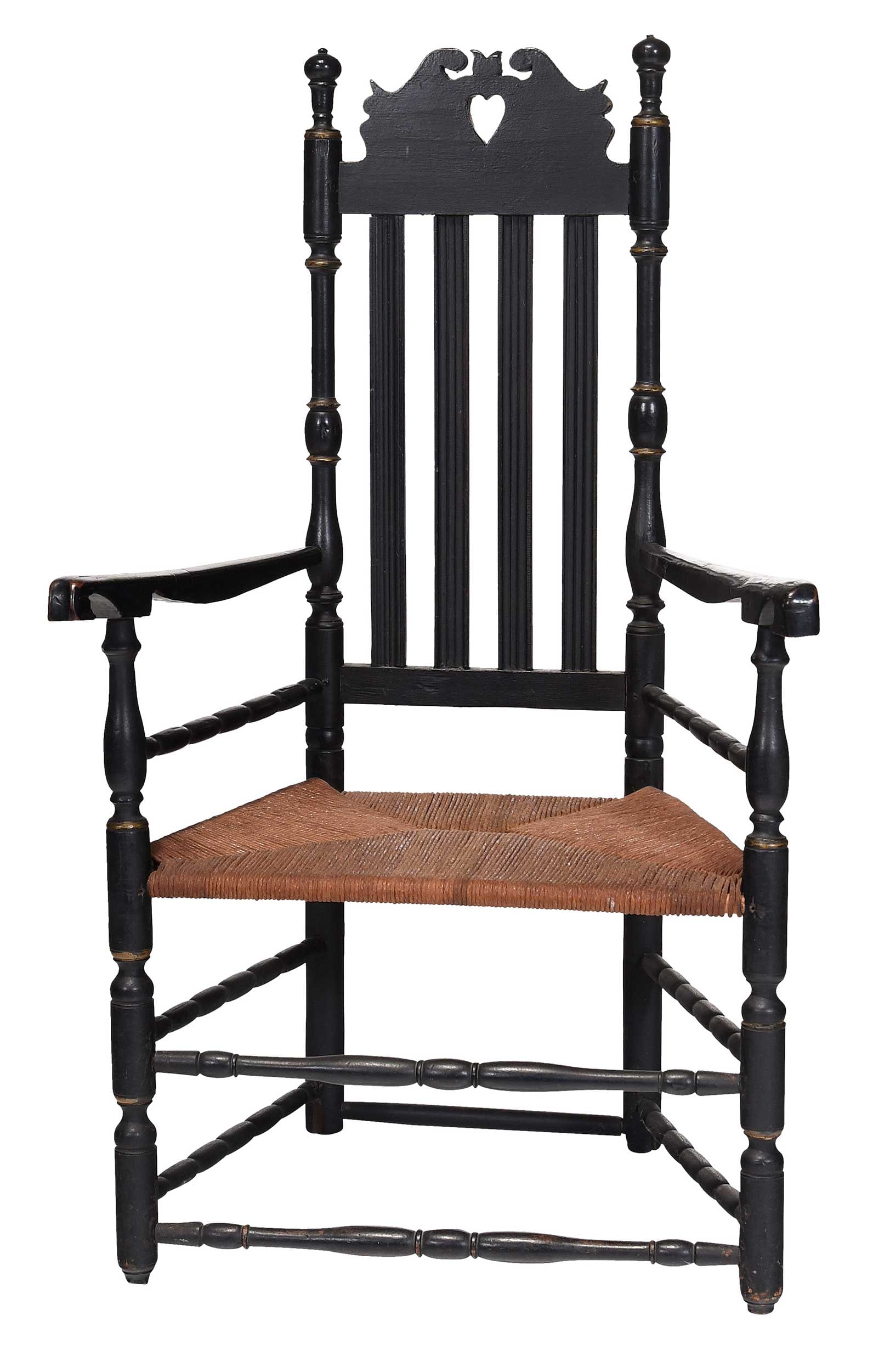 American William and Mary Heart and Crown Bannister Back Armchair: Coastal Connecticut, 18th century, black painted surface with parcel gilt trim, turnings throughout, later rush seat, 43-3/4 x 27-1/2 x 22-1/2 in. Provenance: Estate of Joe and Betsy Byerly, Greensbor