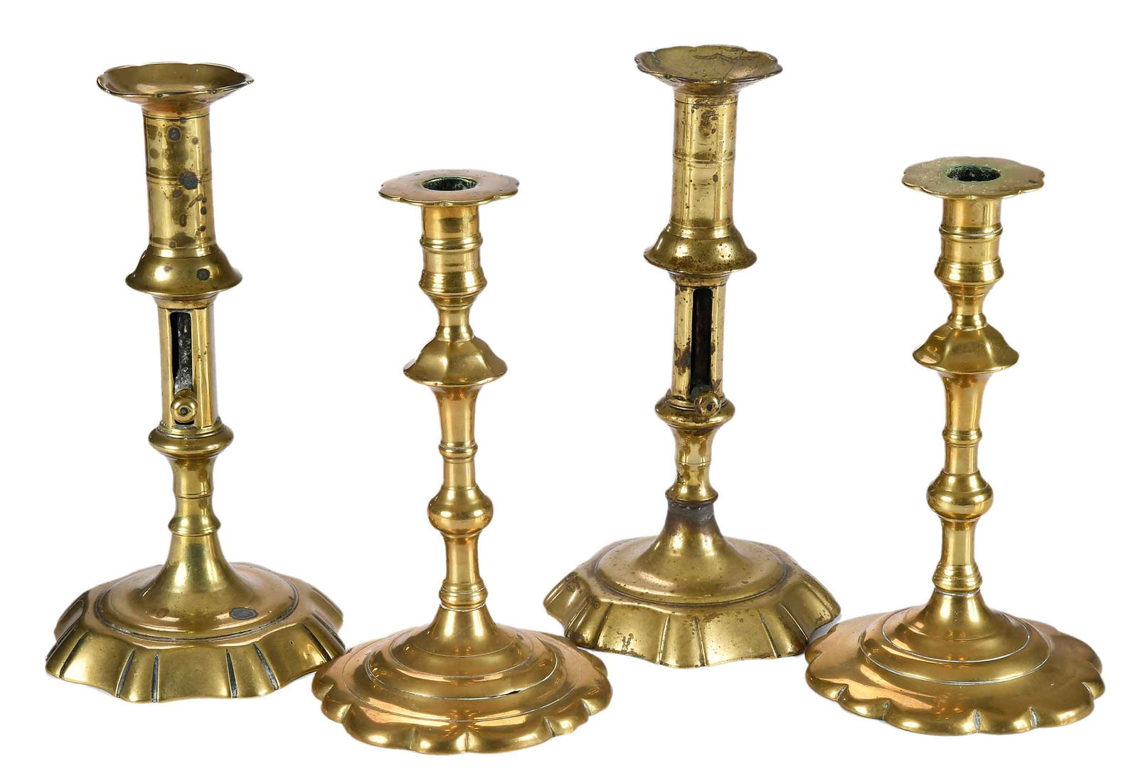 Two Pairs of Brass Candlesticks: probably English, mid 18th century, comprising: pair of brass candlesticks with scalloped bases and wax pans; pair of brass candlesticks with push-up ejectors; larger 8-7/8 x 4-3/4 x 4-3/4 in. Provena