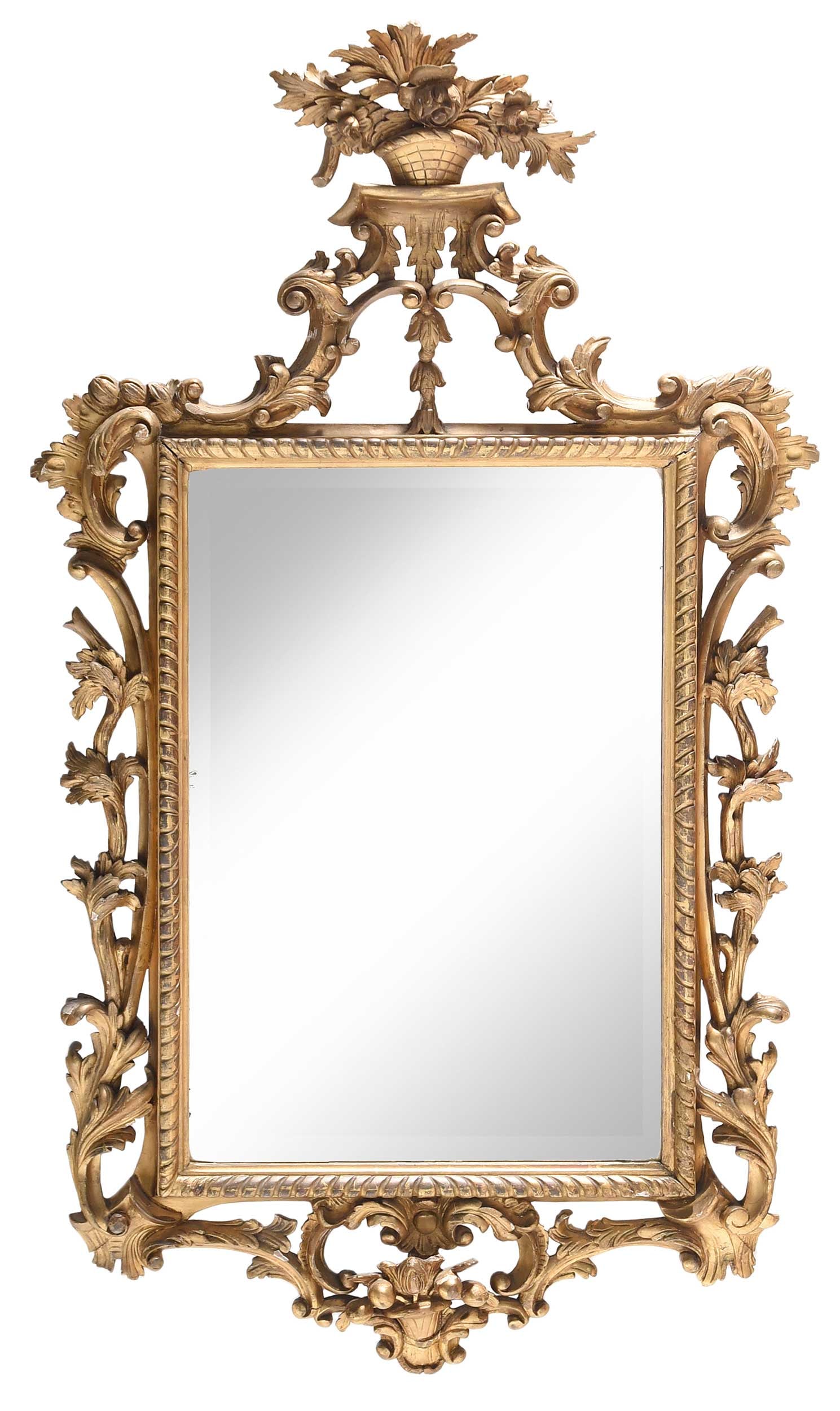 Rococo Carved and Giltwood Mirror: British or Continental, 18th or 19th century, carved giltwood frame crowned with floral basket, 56 x 32-1/2 x 2 in. Provenance: Estate of Joe and Betsy Byerly, Greensboro, North Carolina 