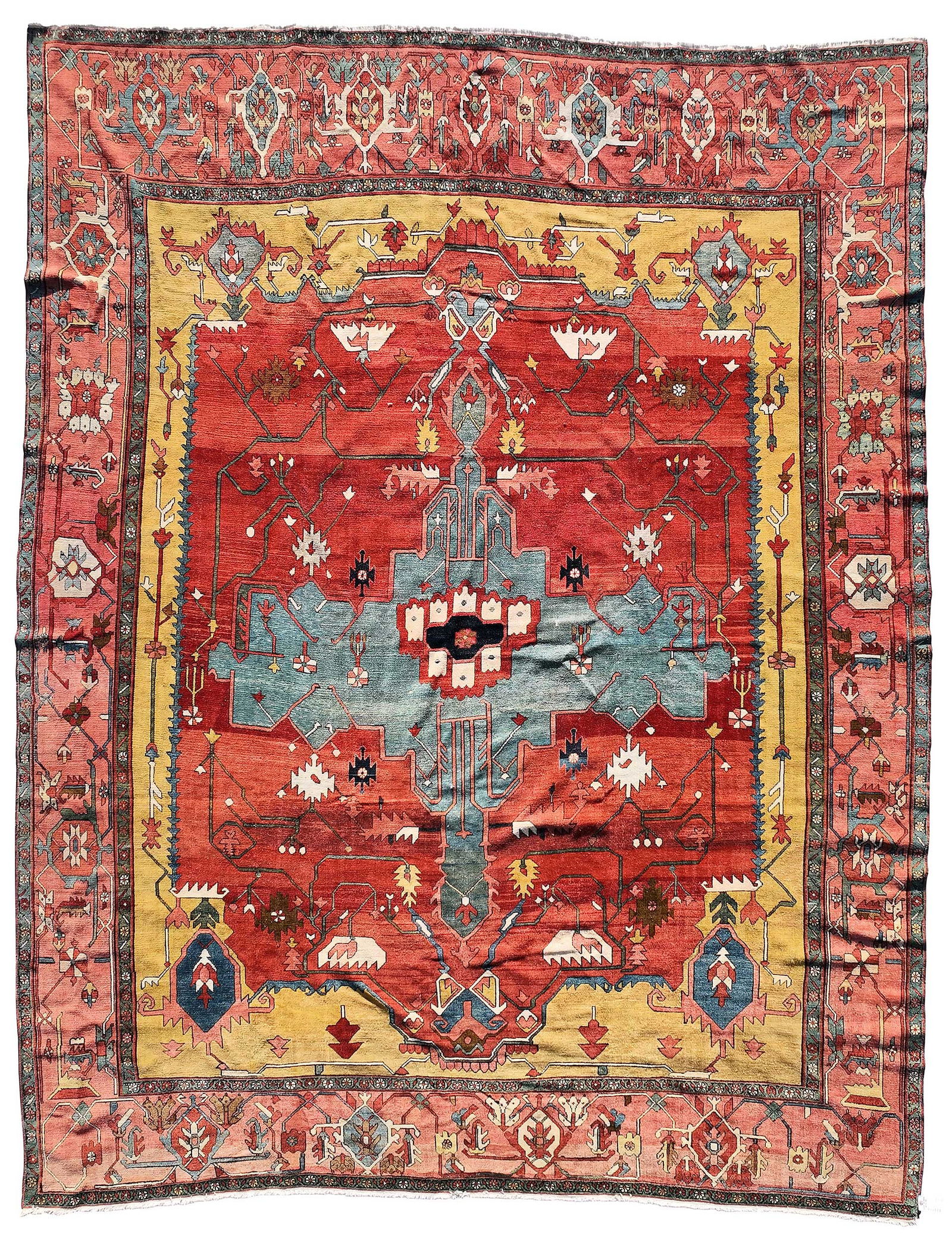 Serapi Carpet: central blue medallion on red ground, red main border with single guards, 13 ft. 6 in. x 10 ft. 9 in. Provenance: Estate of Susan G. Gary, Louisville, Kentucky; Private Collection