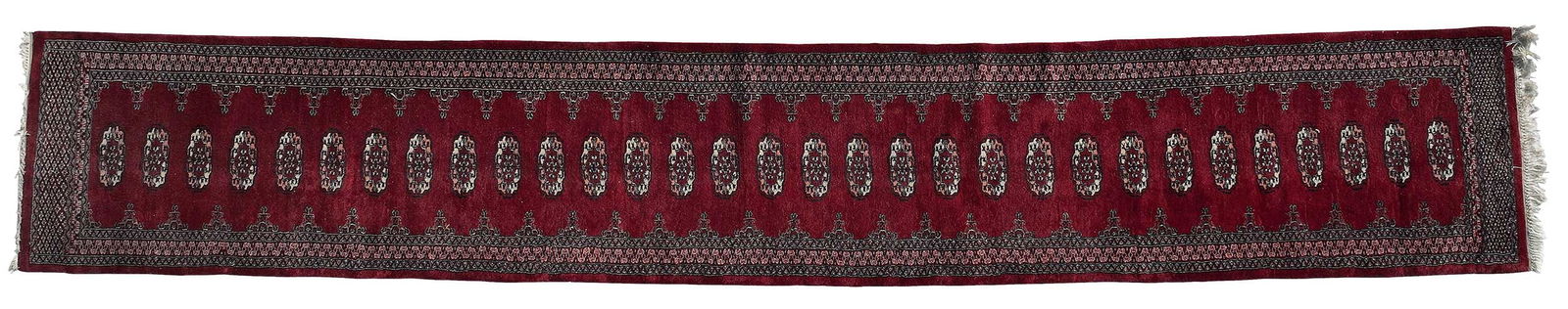 Bokhara Runner: row of medallions on red ground, main border with single guards, 16 ft 9 in. x 3 ft. 10 in.