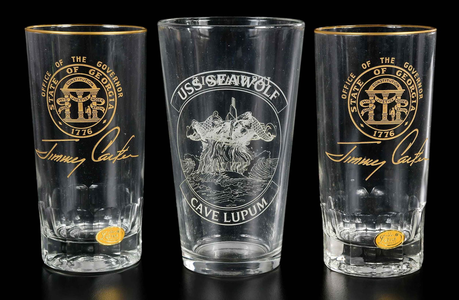 Three Commemorative Glasses, Jimmy Carter Provenance: 20th century, comprising: pair of highball glasses, lettering "Office of the Governor / State of Georgia / 1776 / Jimmy Carter", "21 Karat / Lotus / Quality" stickers, each 5-1/2 x 2-3/4 x 2-3/4 in.;