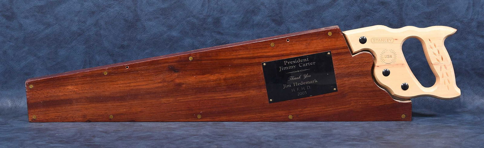 Jimmy Carter Commemorative Hand Saw: American, 20th century, Stanley 20-065 SharpTooth, held in wood sheath with plaque reading "President Jimmy Carter/Thank You/Jim Hedemark H.F.H.D. 2005", 31-1/2 x 7 x 1-1/4 in. Provenance: The Estate
