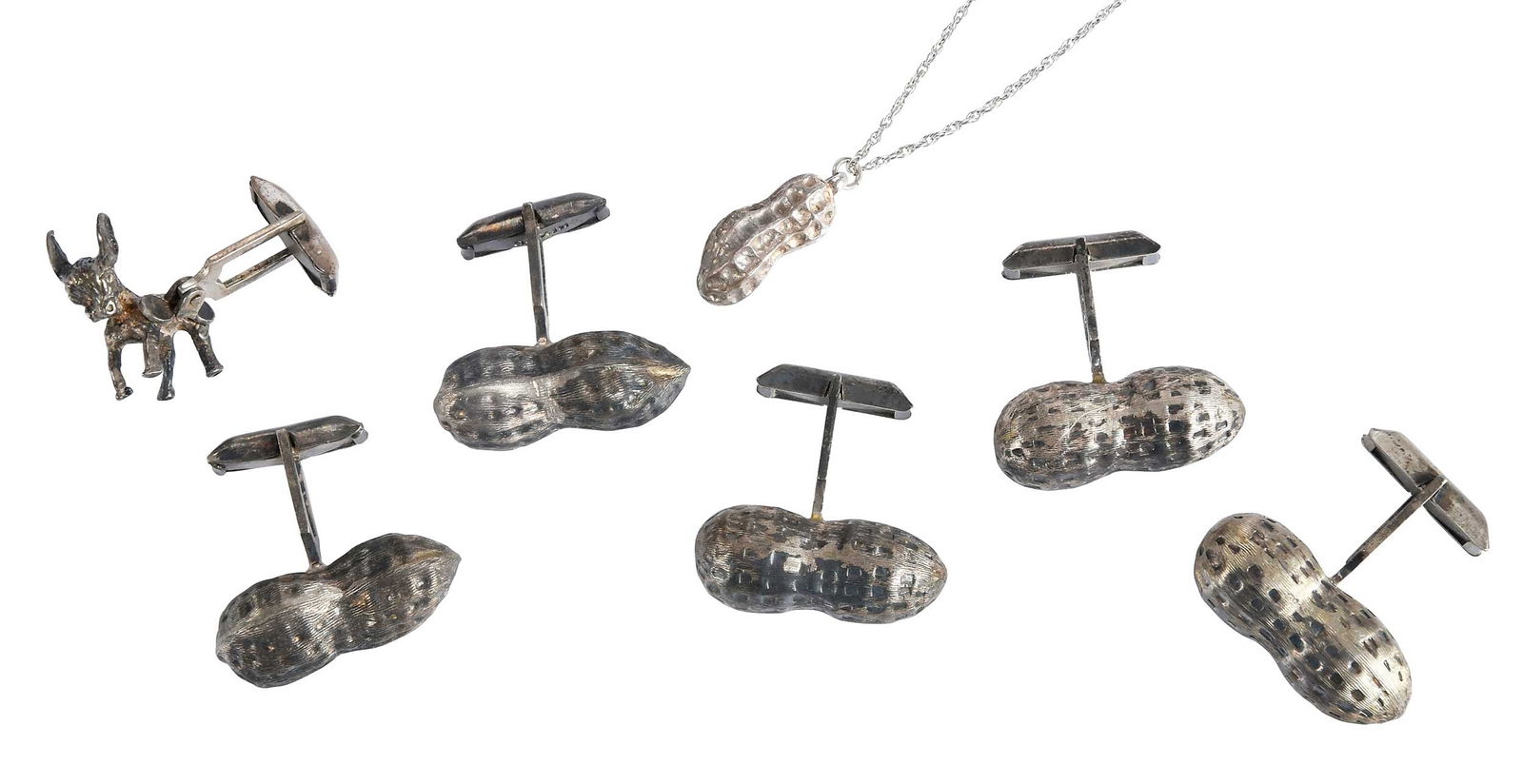 Sterling Peanut Cufflinks and Pendant , Jimmy and Rosalynn Carter Provenance: one pendant on chain, 16 in. length; two sets of cufflinks; two single cufflinks, one peanut and one donkey figure Provenance: The Estate of Jimmy and Rosalynn Carter