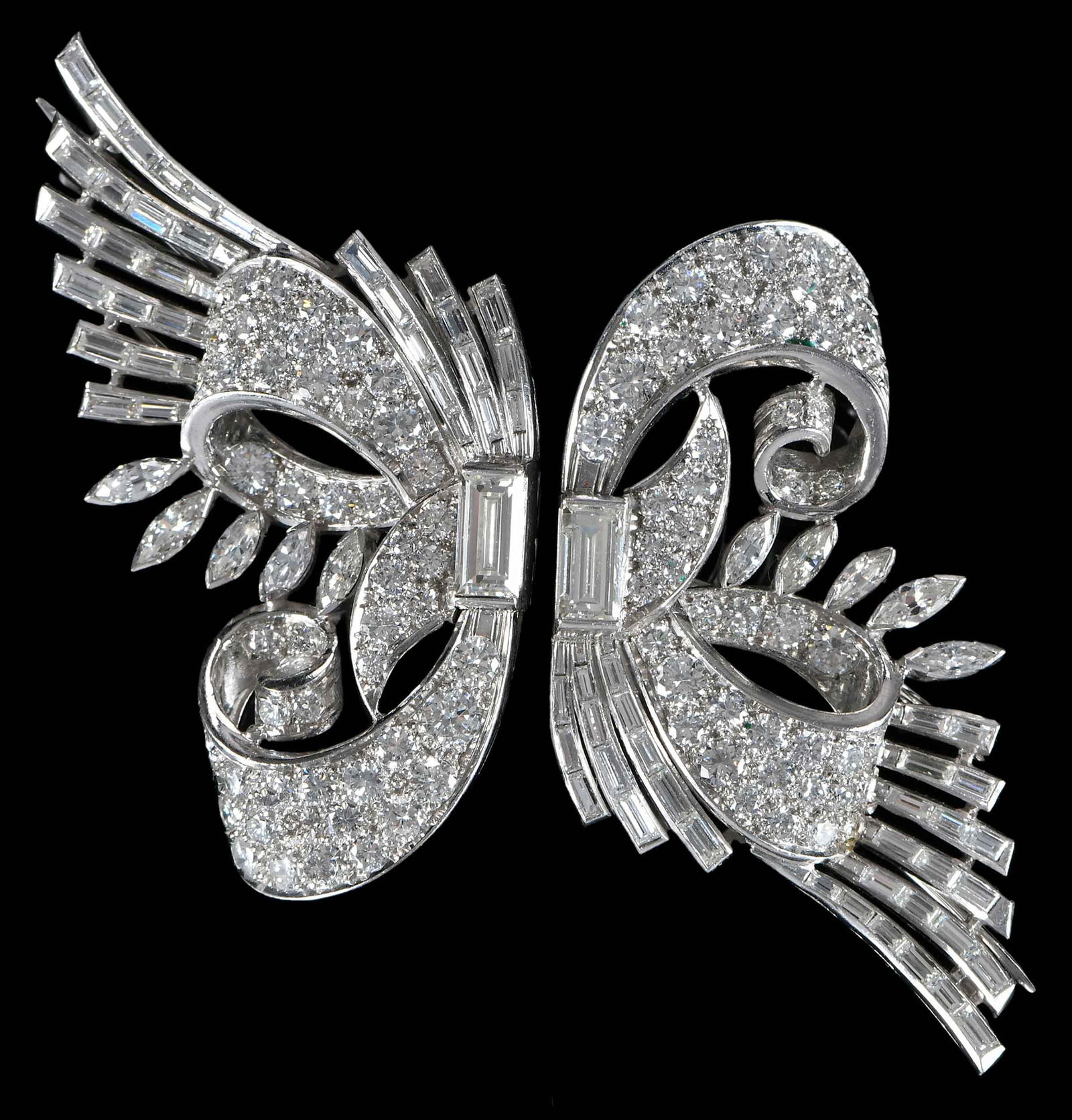 Platinum Pair of Art Deco Diamond Dress Brooches, Bush Family Provenance: straight baguette diamonds, marquise cut diamonds, round full cut diamonds, approx. 11.50ctw., H-J, VS1-VS2, tests platinum, 2 in. across complete, 2-1/4 in. length, 42.6 g Provenance: Estate of Flora