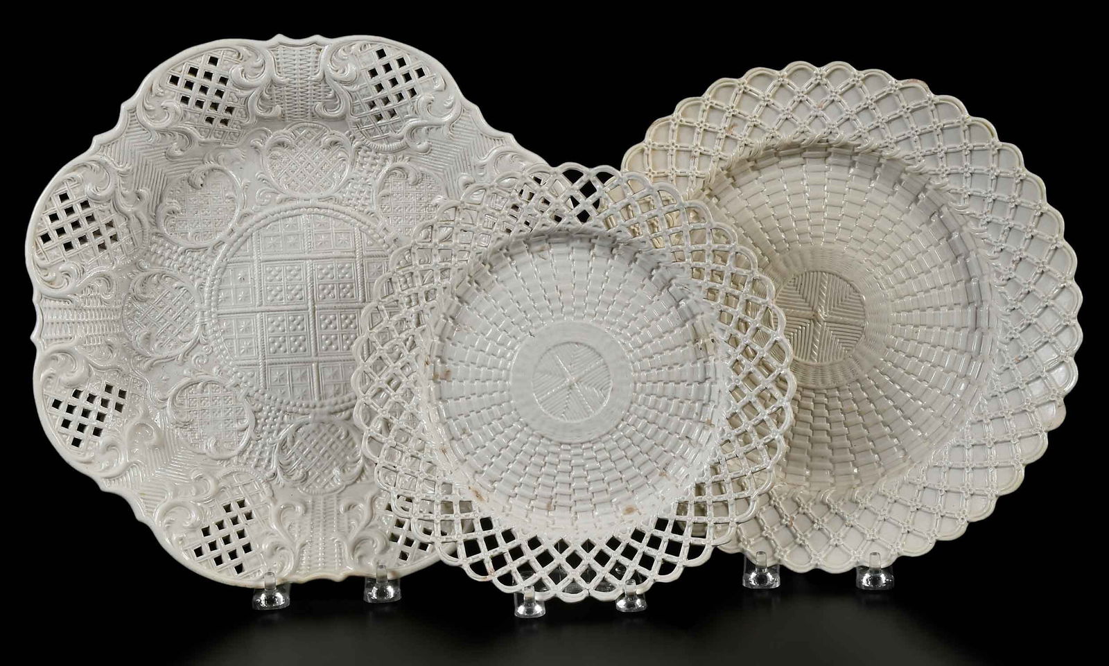 Three Staffordshire Salt Glazed Reticulated Basket Weave Plates: mid/late 18th century, two with reticulated rims, largest 1-3/8 x 11-3/8 x 11-1/2 in. Provenance: Collection of Dr. Richard and Carol Lamb, Kennett Square, Pennsylvania