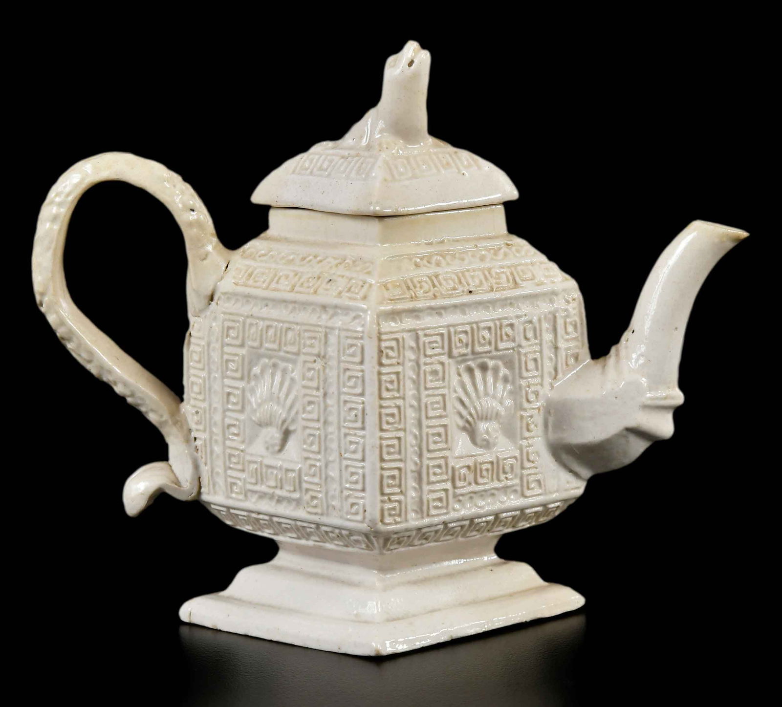 Staffordshire Salt Glazed Lozenge Form Teapot: English, 18th century, pecten shell and Greek key motif, animal form finial, 4 x 5 x 2-1/4 in. Provenance: Collection of Dr. Richard and Carol Lamb, Kennett Square, Pennsylvania