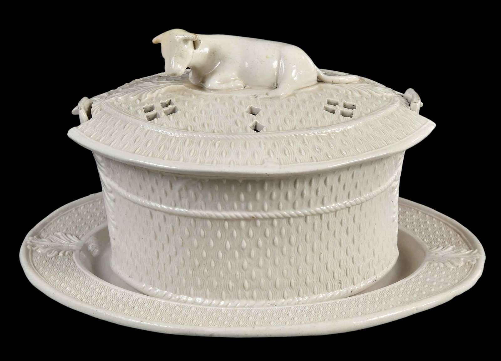 Staffordshire White Salt Glazed Butter Tub and Underplate: English, 18th century, with cow finial, 4-3/8 x 6-1/8 x 5 in.; underplate 5/8 x 8 x 6-5/8 in. Provenance: Collection of Dr. Richard and Carol Lamb, Kennett Square, Pennsylvania