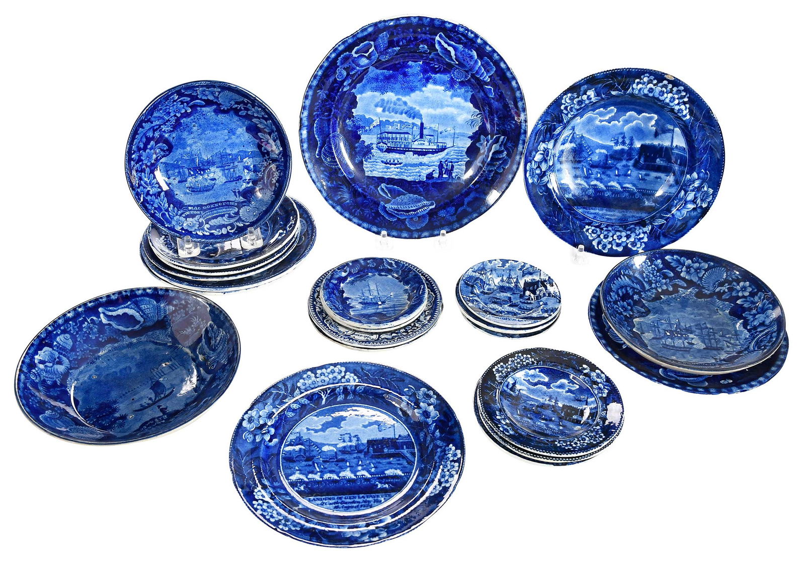 22 Historic Blue Staffordshire Dishes: English, early 19th century, each with American and nautical scenes, various sizes from 1/2 x 3-5/8 x 3-5/8 in. to 1 x 8-1/4 x 8-1/4 in. Provenance: Collection of Dr. Richard and Carol Lamb, Kennett S