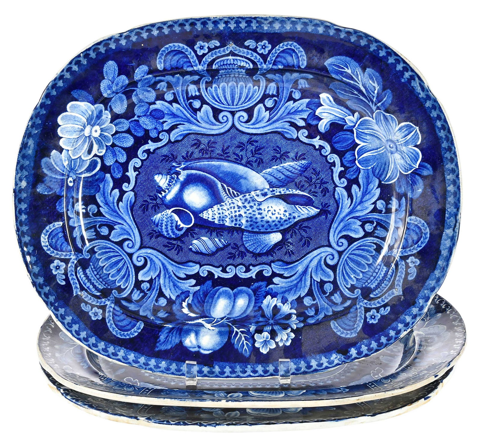 Three Large Blue Staffordshire Platters: English, early 19th century, each with fruit and shell still life scenes, all approximately 1-1/4 x 16-1/2 x 13-3/8 in. Provenance: Collection of Dr. Richard and Carol Lamb, Kennett Square, Pennsylvan